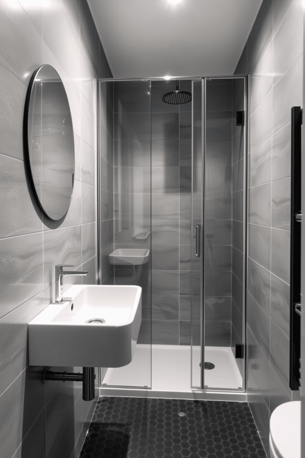 A contemporary 5x5 bathroom features a sleek wall-mounted sink that maximizes floor space while maintaining a minimalist aesthetic. The walls are adorned with large-format tiles in soft gray tones, creating a serene backdrop for the design. A frameless glass shower enclosure enhances the feeling of openness, complemented by a rainfall showerhead for a luxurious touch. The floor is finished with small hexagonal tiles in a contrasting dark shade, adding visual interest and texture to the space.