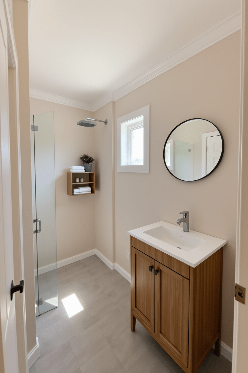 A serene 5x5 bathroom featuring a neutral color palette that enhances a calm ambiance. The walls are painted in soft beige, complemented by white trim and a light gray tile floor. A minimalist wooden vanity with a smooth white countertop holds a single sink. Above the vanity, a round mirror with a simple black frame reflects the natural light streaming in from a small window. To the left of the vanity, a compact shelving unit displays neatly folded towels and decorative items. A small potted plant adds a touch of greenery, bringing life to the tranquil space. The shower area features a clear glass door and a rain showerhead, creating an open feel. Soft, ambient lighting illuminates the room, enhancing the overall soothing atmosphere.