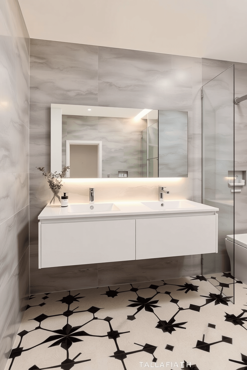 A modern bathroom featuring a floating vanity with sleek lines and under-cabinet lighting that creates a warm glow. The walls are adorned with large format tiles in a soft gray tone, complementing the minimalist aesthetic. The floor showcases a geometric patterned tile in black and white, adding visual interest to the space. A large frameless mirror above the vanity reflects the stylish fixtures and enhances the sense of openness.