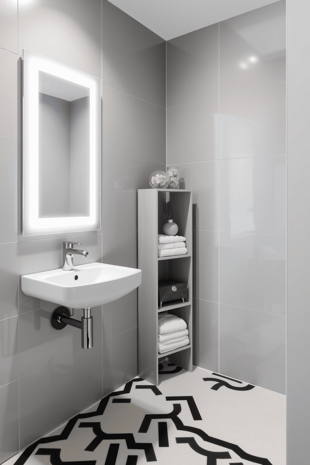 A modern bathroom featuring a wall-mounted sink to maximize floor space. The walls are adorned with sleek tiles in a soft gray hue, complemented by a large mirror that enhances the room's brightness. The floor showcases a stylish geometric pattern in black and white. A compact shelving unit with neatly arranged towels and decorative items adds functionality and charm to the space.