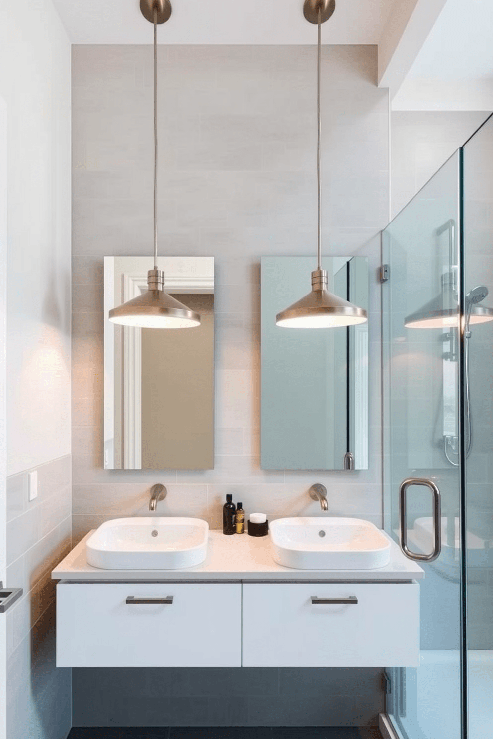 Stylish pendant lighting hangs gracefully above the double sinks in a modern 8x10 bathroom. The fixtures feature sleek lines and a brushed nickel finish, casting a warm glow that enhances the contemporary aesthetic. The walls are adorned with soft gray tiles that provide a clean backdrop for the elegant design. A frameless glass shower enclosure complements the space, allowing natural light to filter through while maintaining an open feel.