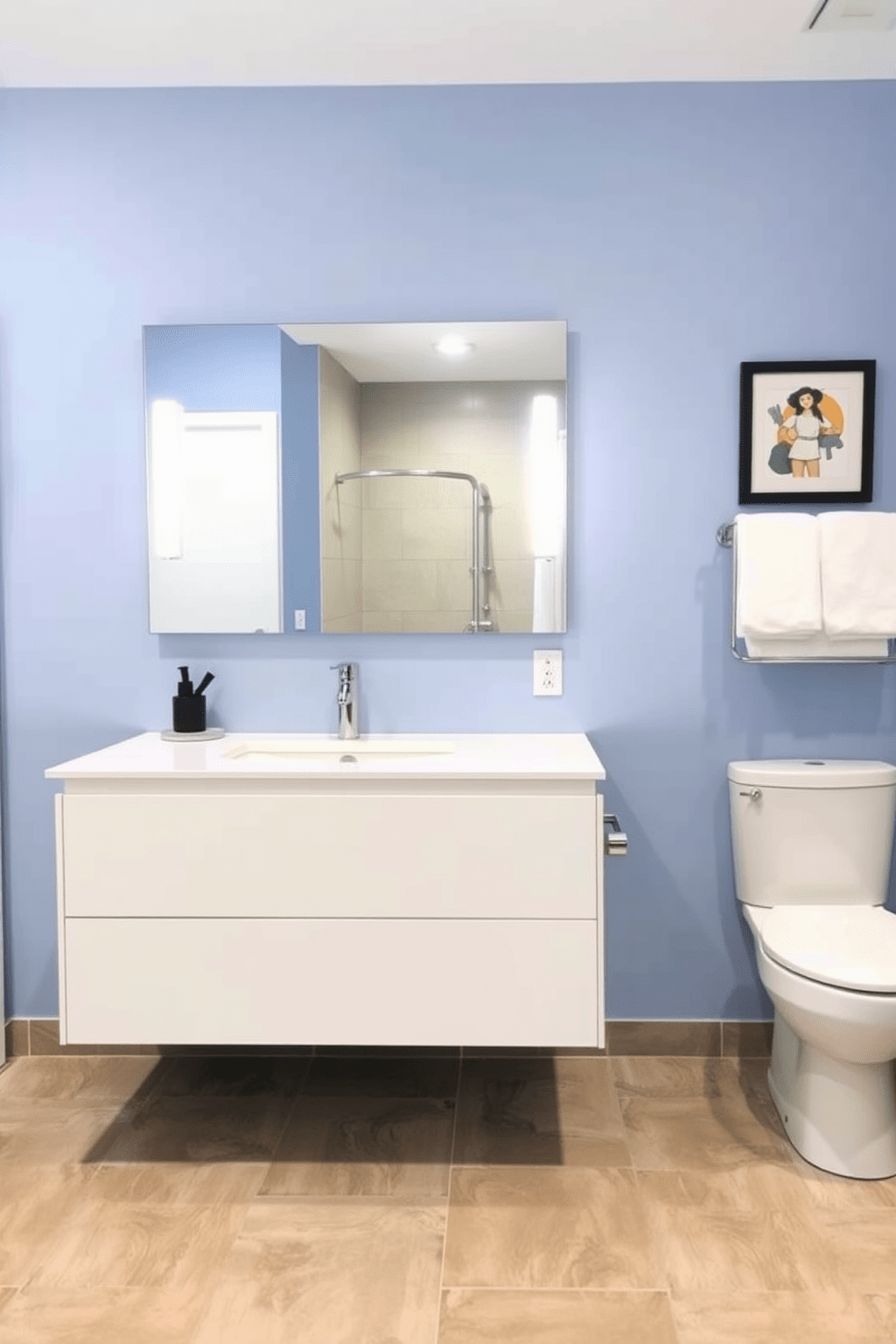 A modern ADA compliant bathroom featuring a floating vanity designed for wheelchair clearance. The vanity is crafted from sleek white cabinetry with a polished chrome faucet and a large mirror above it reflecting the spacious layout. The walls are painted in a soft blue hue, creating a calming atmosphere. The floor is covered with large, non-slip tiles in a neutral tone, ensuring safety and accessibility throughout the space.