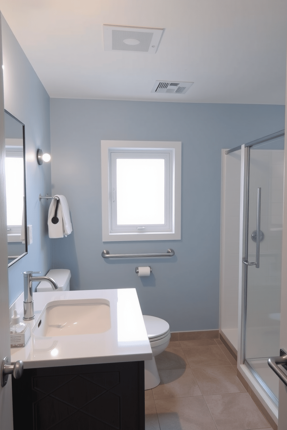 A modern ADA compliant bathroom featuring accessible light switches installed at lower heights for easy reach. The walls are painted in a soft blue hue, and the flooring is a slip-resistant tile in a neutral tone. The vanity is designed with a lower countertop to accommodate wheelchair users, paired with a stylish undermount sink. Grab bars are strategically placed near the shower and toilet for added safety and support. Natural light floods the space through a frosted window, enhancing the calming atmosphere. A minimalist aesthetic is achieved with simple decor and functional storage solutions.