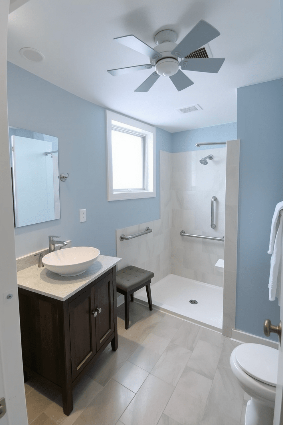 A spacious ADA-compliant bathroom featuring a roll-in shower with grab bars and a fold-down bench. The walls are painted in a soft blue hue, and the floor is covered with non-slip tiles for safety. A stylish wooden vanity with a quartz countertop is equipped with a vessel sink and lever faucets for easy access. Natural light floods the space through a frosted window, complemented by an exhaust fan discreetly installed on the ceiling to enhance ventilation.