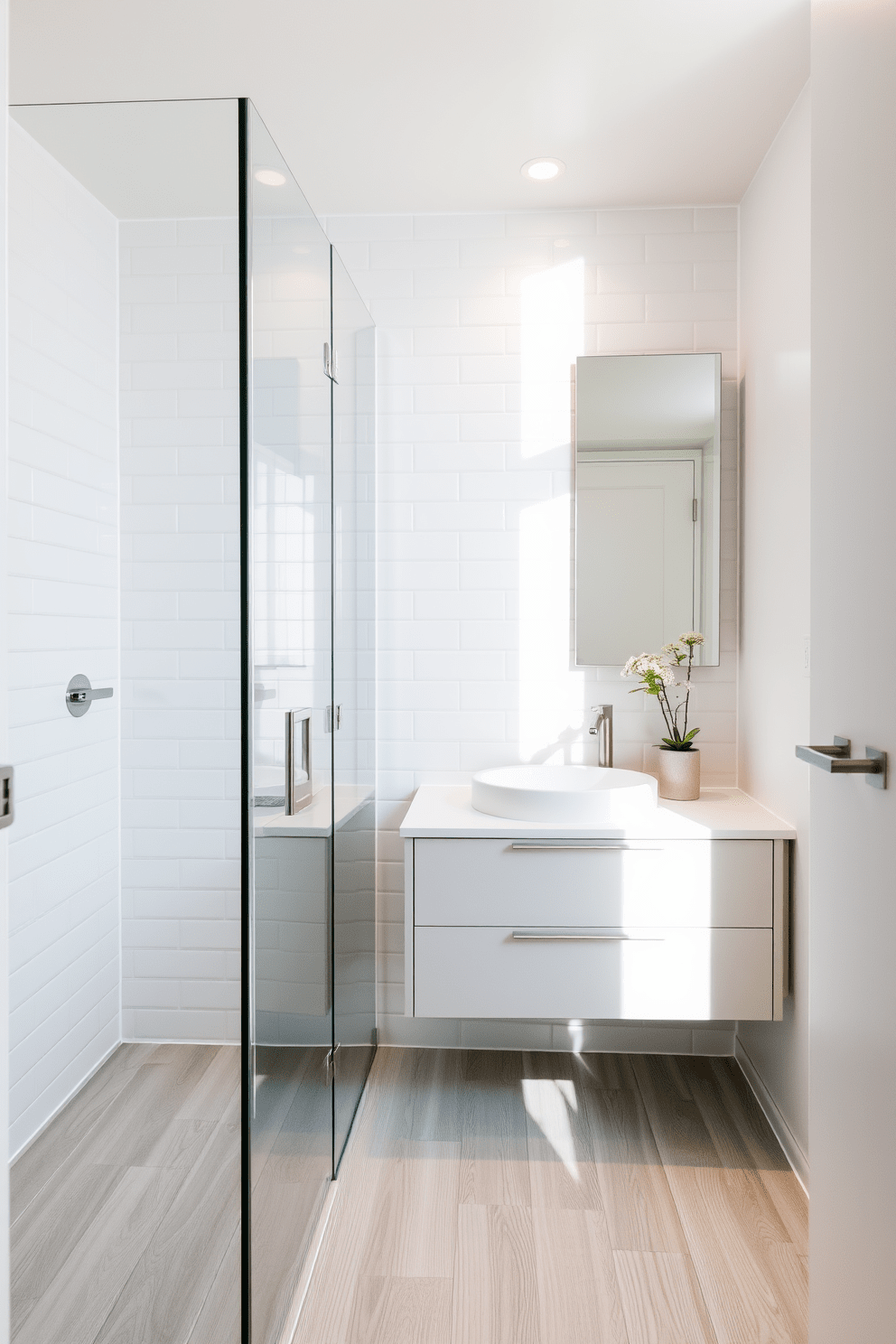 A light and airy apartment bathroom featuring a sleek glass shower enclosure that maximizes natural light. The walls are adorned with soft white tiles, and the floor boasts a light gray wood-look laminate for a warm yet modern feel. A minimalist vanity with a floating design complements the space, topped with a simple round sink and brushed nickel fixtures. Soft, ambient lighting illuminates the area, creating a serene atmosphere perfect for relaxation.