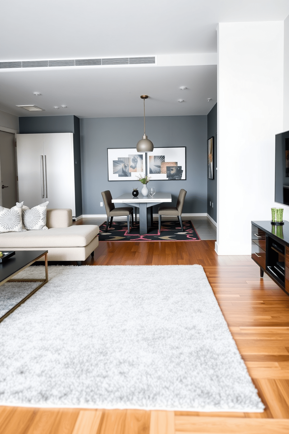 A modern apartment living room featuring a cozy area rug that defines the seating area. The rug is layered over hardwood flooring, complementing a plush sectional sofa and a sleek coffee table. In the dining area, a bold geometric rug anchors a stylish dining table surrounded by upholstered chairs. The rug adds warmth and texture, enhancing the overall aesthetic of the open-concept space.