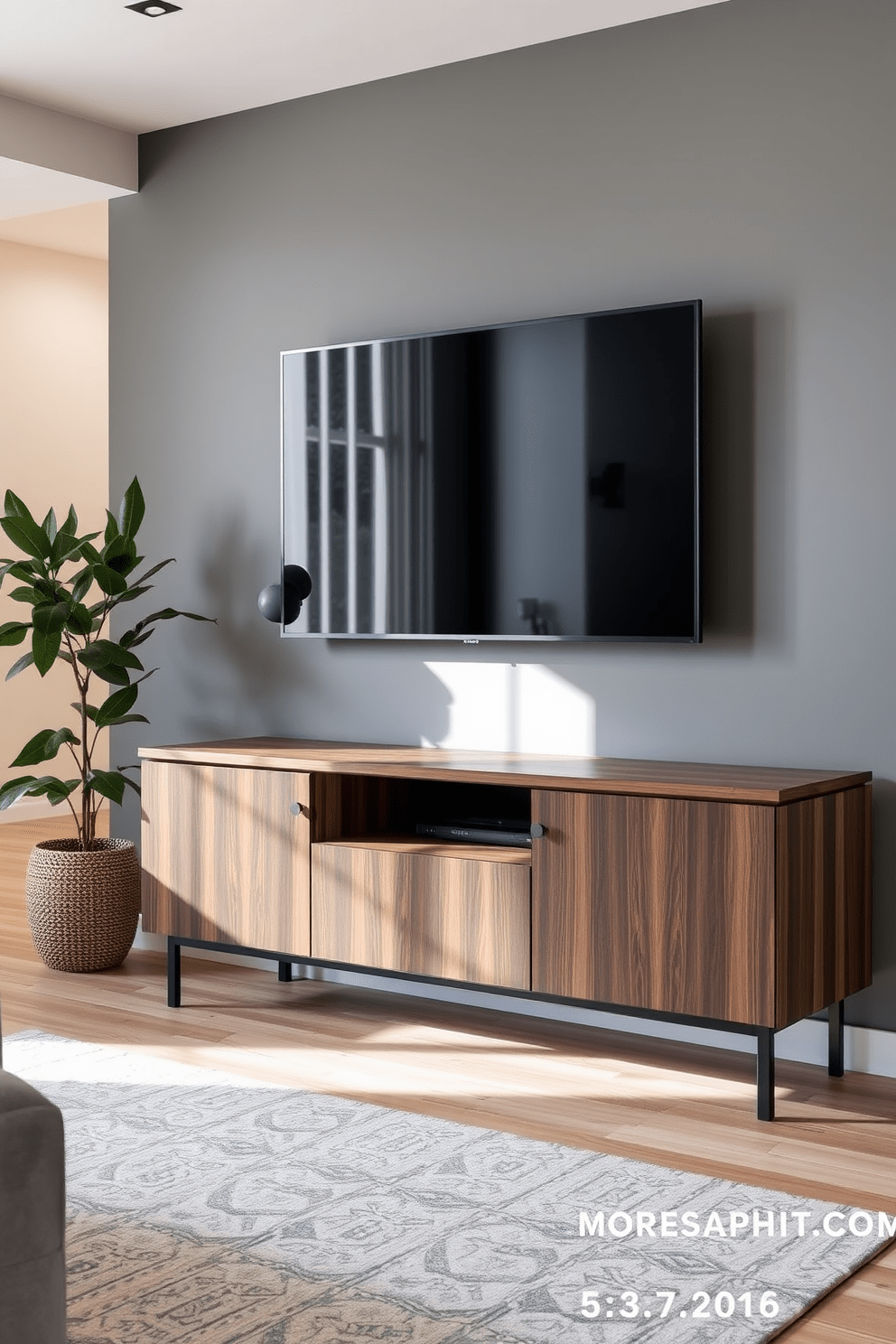 A modern apartment living room featuring a wall-mounted TV above a sleek media console. The console is made of dark wood with clean lines, and the wall is painted in a soft gray tone to create a cozy atmosphere.