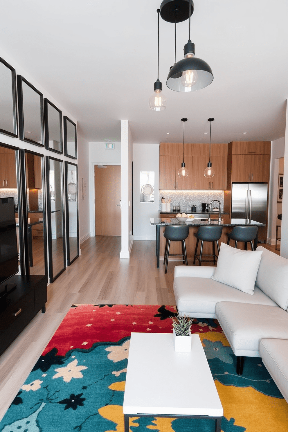 A modern apartment with framed mirrors strategically placed to create depth and enhance the sense of space. The living area features a sleek sectional sofa, a minimalist coffee table, and a vibrant area rug that adds warmth to the room. The kitchen boasts stainless steel appliances and an island with bar seating, perfect for casual dining. Industrial-style pendant lights hang above, illuminating the contemporary decor and providing a stylish focal point.