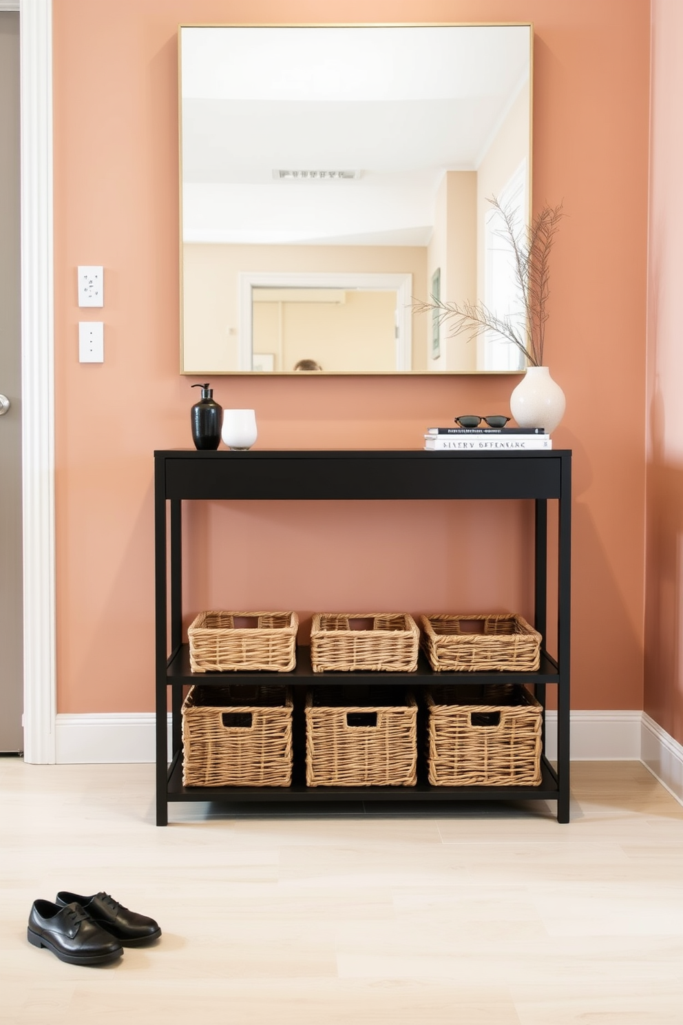 A stylish apartment entryway featuring a sleek console table against the wall. Below the table, woven baskets are neatly arranged to provide organized shoe storage, enhancing both functionality and aesthetics. The walls are painted in a warm neutral tone, creating an inviting atmosphere. A large mirror hangs above the console, reflecting light and making the space feel more expansive.