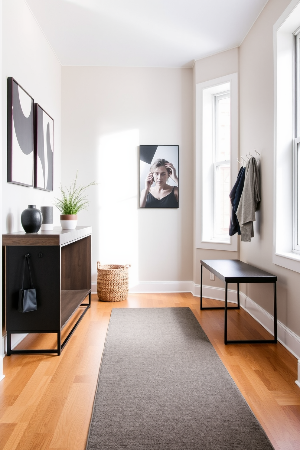 A stylish apartment entryway features a long runner rug that delineates the space and adds warmth. The walls are adorned with modern art, and a sleek console table holds decorative items and a small potted plant. To the side, a minimalist bench provides seating, complemented by a set of hooks for coats and bags. Natural light pours in through a nearby window, enhancing the inviting atmosphere of the entryway.