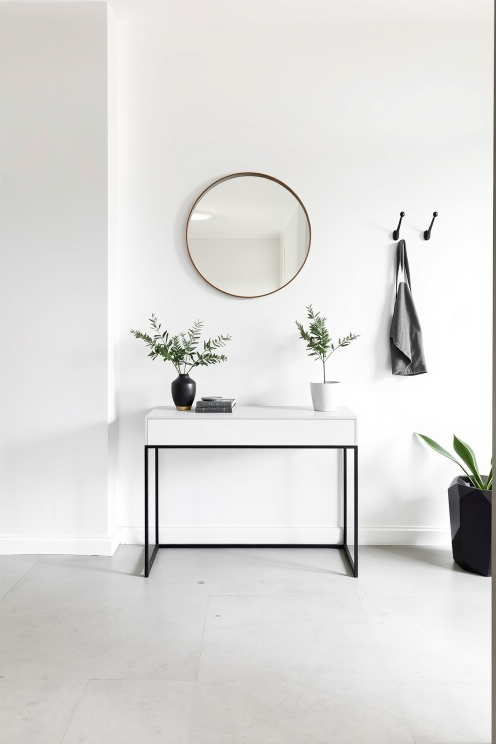 A minimalist entryway featuring clean lines and a neutral color palette. The space includes a sleek console table with a simple geometric design and a round mirror above it. To the side, a pair of minimalist coat hooks are mounted on the wall, and a small potted plant adds a touch of greenery. The flooring is a polished concrete, providing a modern and airy feel to the entryway.