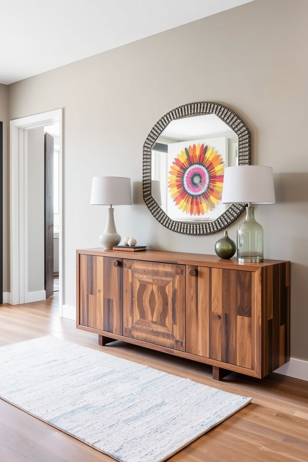 A stylish apartment entryway featuring a statement piece of furniture. The focal point is a large, sleek console table made of reclaimed wood, adorned with a decorative mirror above it and a vibrant piece of art on the wall.