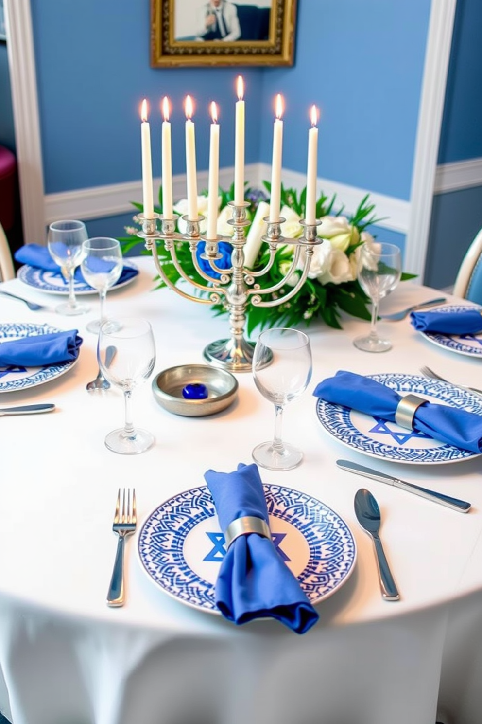 A festive blue and white table setting is elegantly arranged for a Hanukkah celebration. The table is adorned with a crisp white tablecloth, complemented by blue and white patterned plates and shimmering silverware. Candles are placed in a beautiful menorah at the center, casting a warm glow over the scene. Delicate blue napkins are folded artfully beside each plate, adding a touch of sophistication to the festive atmosphere.