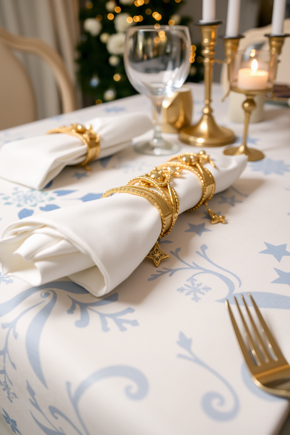 Festive napkin rings adorned with gold accents rest elegantly on a beautifully set dining table. The rings complement a winter-themed tablecloth featuring soft blues and whites, enhancing the warm ambiance of the Hanukkah celebration.