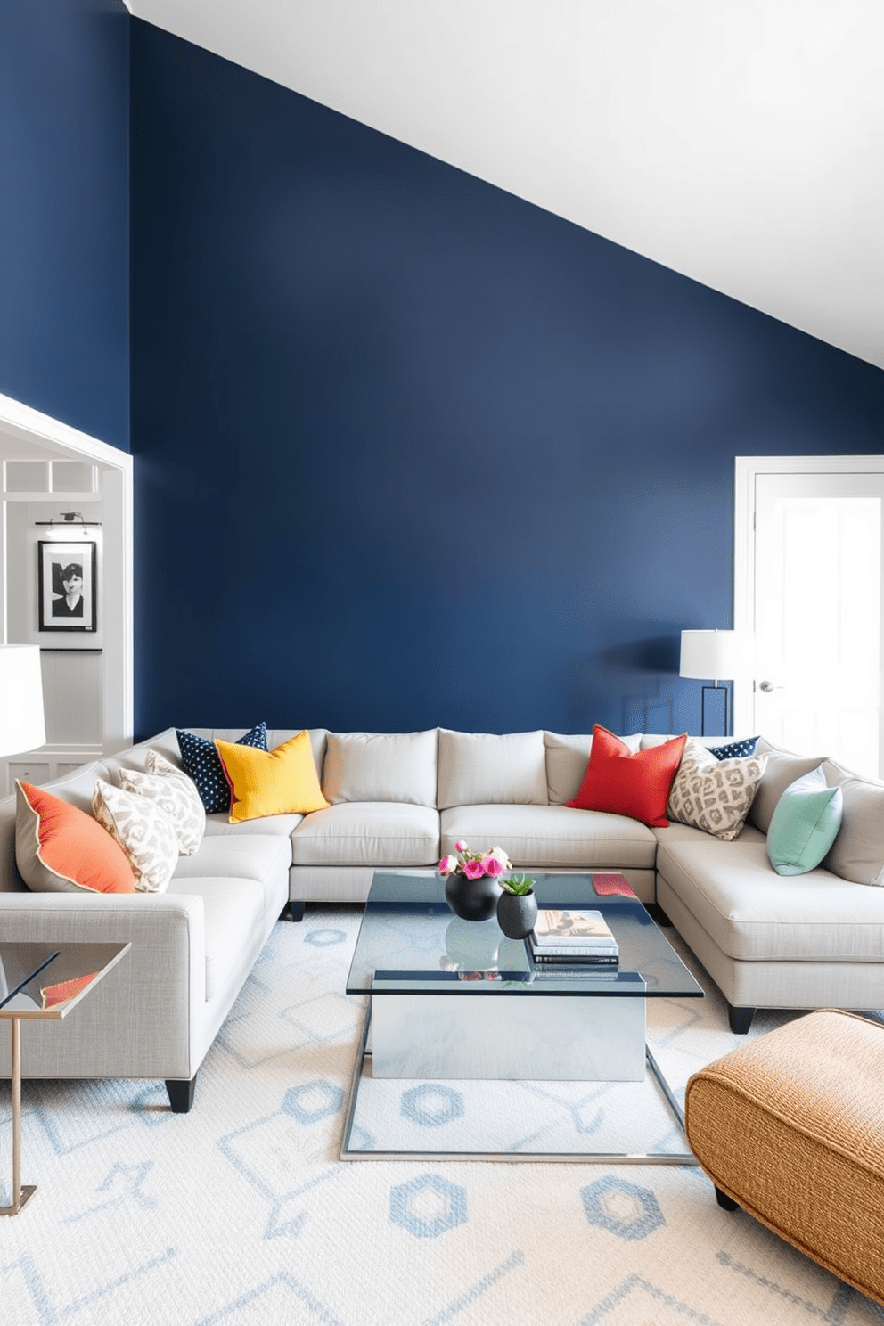 A striking living room featuring a bold accent wall painted in deep navy blue. The rest of the walls are a soft white, creating a stunning contrast that draws the eye. A plush sectional sofa in a light gray fabric is arranged around a sleek glass coffee table. Colorful throw pillows in various textures add warmth and personality to the space.