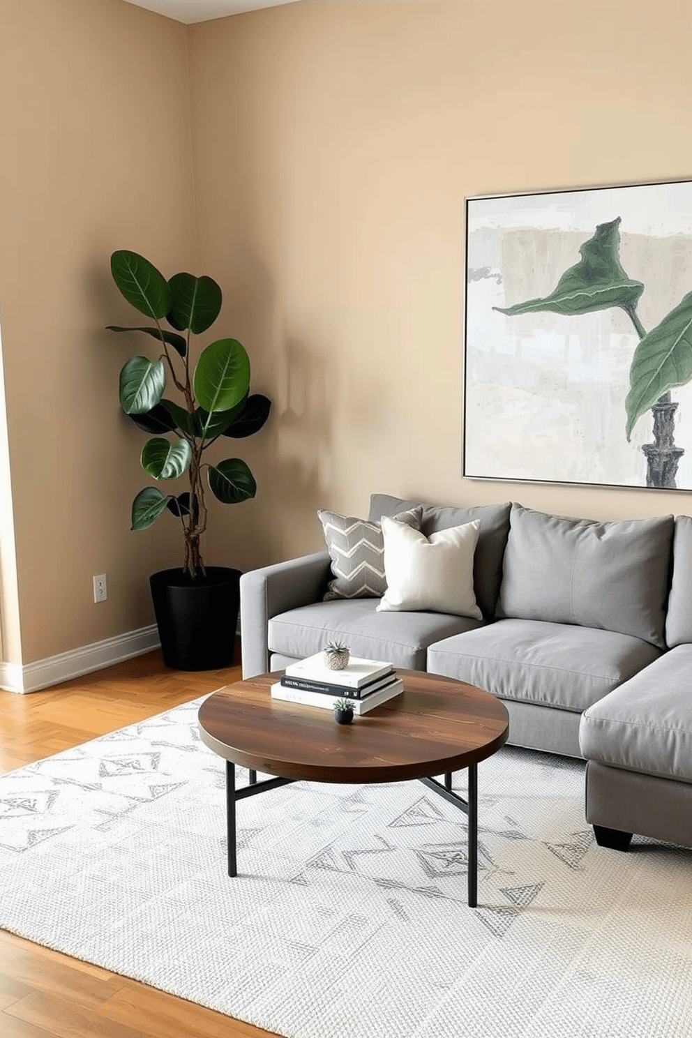 A stylish apartment living room featuring a cozy sectional sofa in a soft gray fabric. A large potted fiddle leaf fig plant stands in the corner, adding a touch of greenery to the space. The walls are painted in a warm beige tone, complemented by a large abstract artwork above the sofa. A round coffee table made of reclaimed wood sits in the center, adorned with a few decorative books and a small succulent.