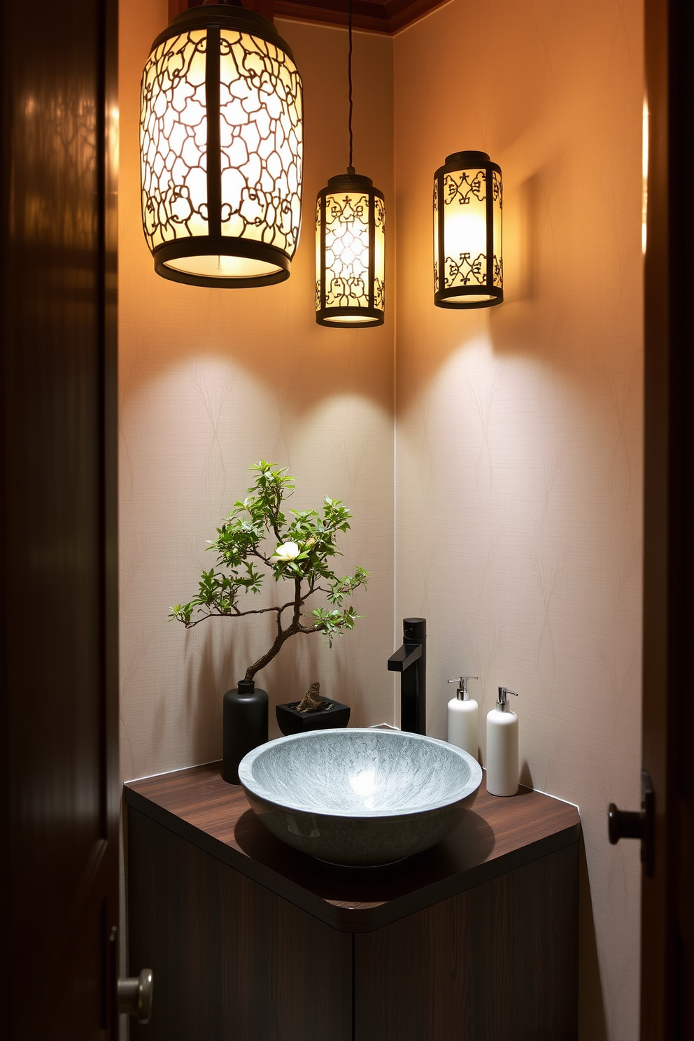 A serene Asian powder room features intricate lanterns that cast a warm, inviting glow throughout the space. The walls are adorned with delicate bamboo wallpaper, complementing the natural wood accents and creating a tranquil atmosphere. The vanity boasts a sleek, dark wood finish with a subtle grain, paired with a striking vessel sink made of polished stone. Decorative elements include a small bonsai tree and elegant ceramic soap dispensers that enhance the overall aesthetic.