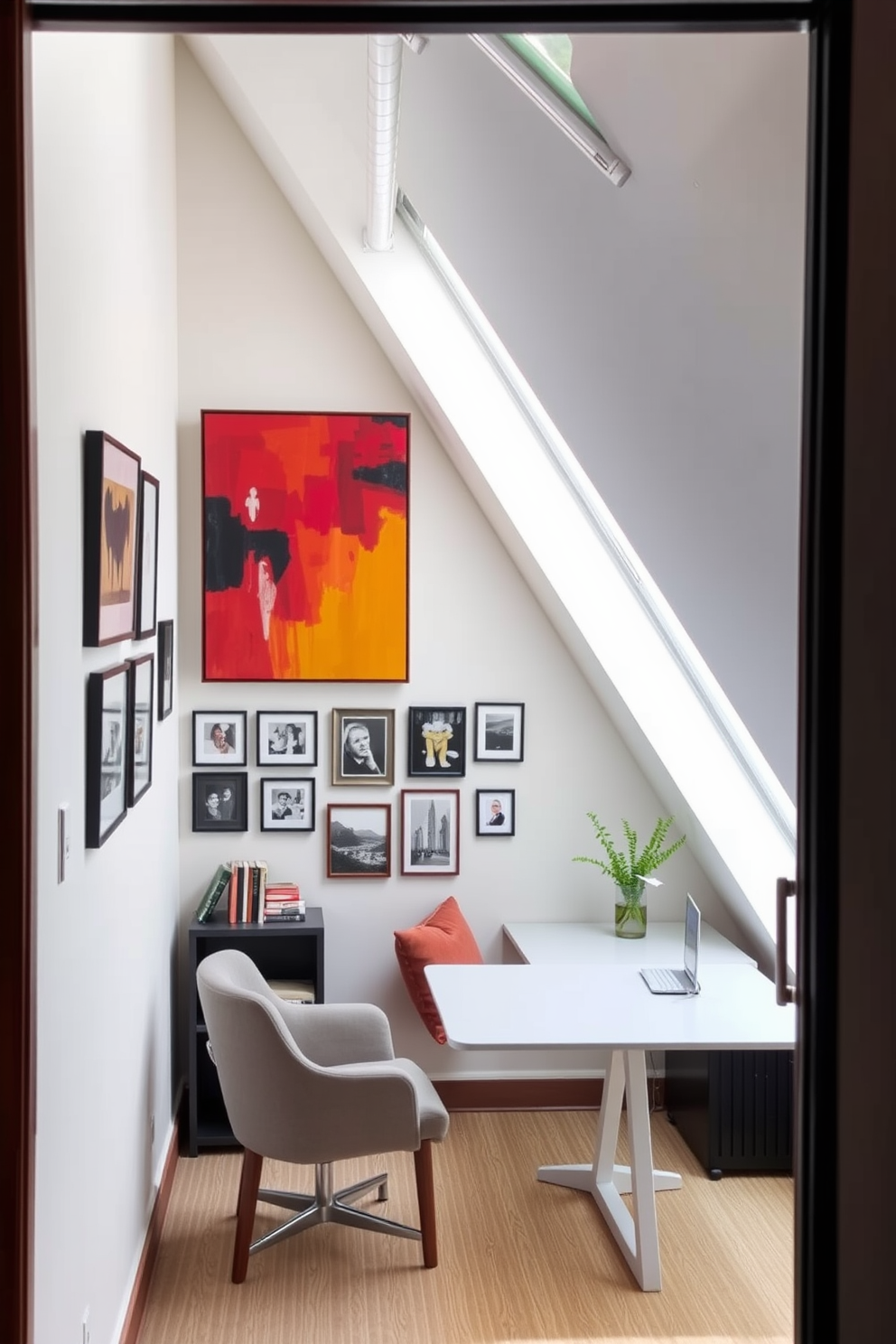 Creative wall art for inspiration. A vibrant abstract painting hangs above a sleek, minimalist desk, adding a pop of color to the room. Surrounding the artwork are framed photographs in various sizes, creating a gallery wall that inspires creativity and reflection. Attic Office Design Ideas. The space features a cozy reading nook with a plush armchair and a small bookshelf, perfect for quiet moments of inspiration. A large skylight floods the room with natural light, illuminating a modern desk positioned under the sloped ceiling, enhancing productivity and focus.