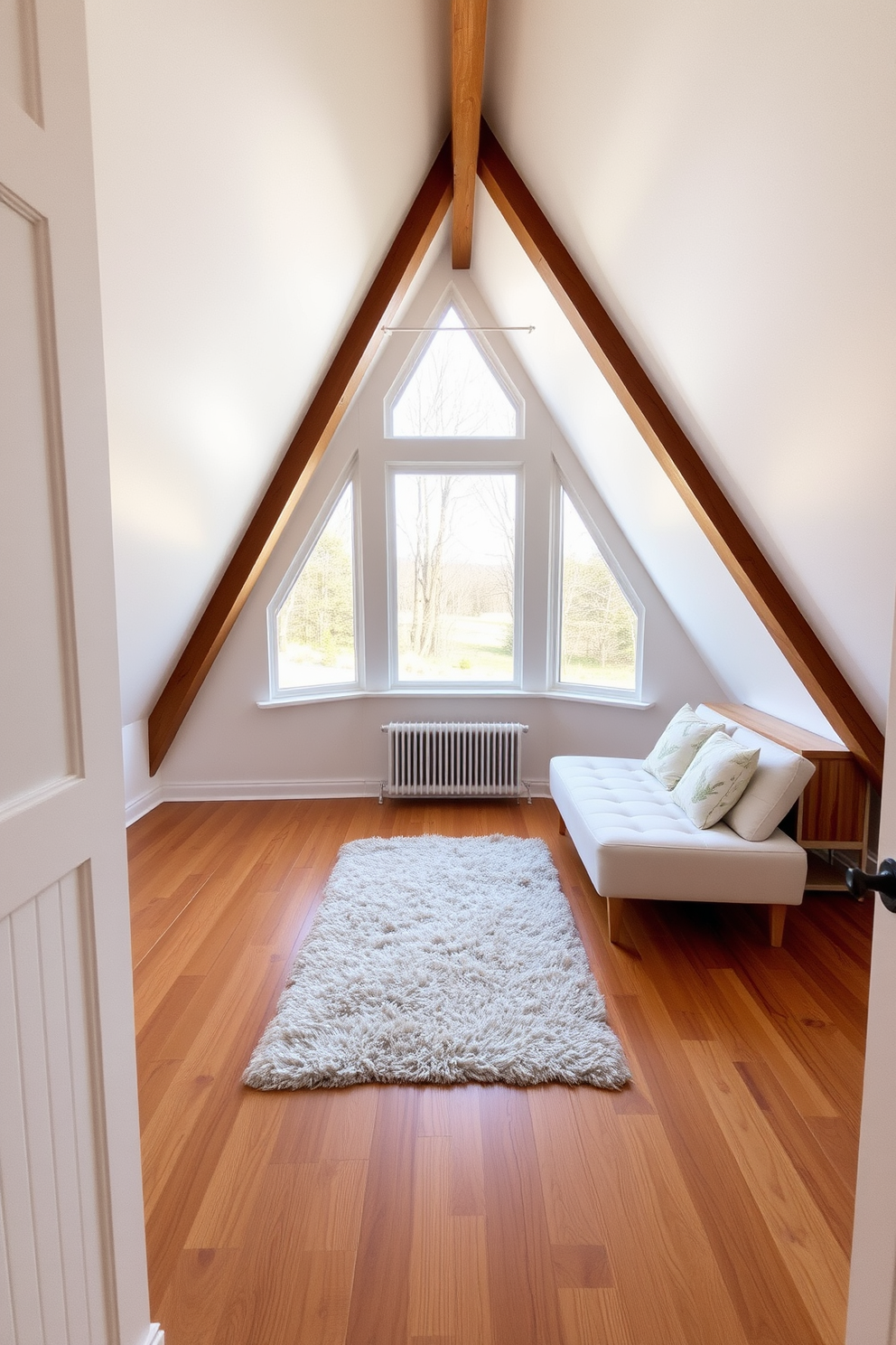 A cozy attic space featuring large triangular windows that allow natural light to flood in. The wooden flooring complements the window design with warm tones that enhance the inviting atmosphere. The walls are painted in a soft white to create a bright and airy feel. A plush area rug sits beneath a small seating area, adding texture and comfort to the room.