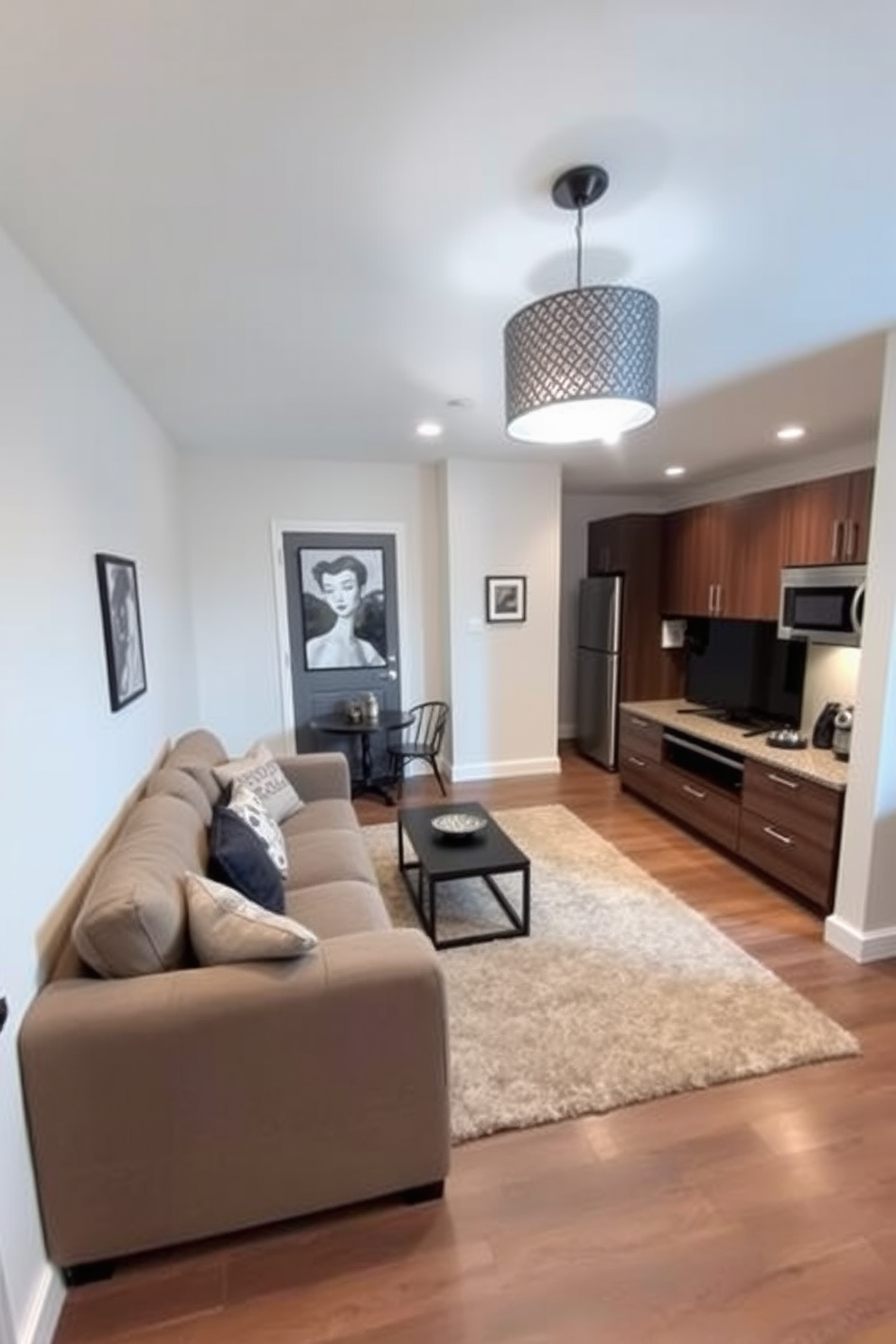 A cozy basement apartment featuring an open-concept living area with a plush sectional sofa facing a sleek entertainment unit. The space is illuminated by soft lighting, and a large area rug anchors the seating arrangement, adding warmth and comfort. The kitchen area showcases modern cabinetry with stainless steel appliances and a small dining table for two. A decorative pendant light hangs above the table, creating an inviting atmosphere for meals.