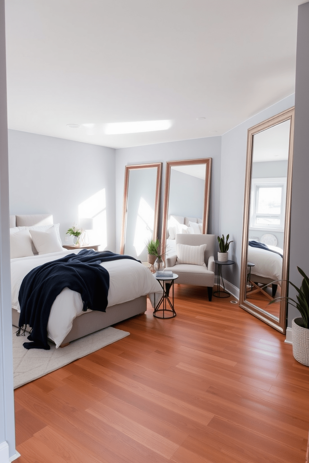 A cozy basement bedroom featuring large mirrors strategically placed to enhance natural light. The walls are painted a soft gray, and the room is furnished with a plush bed dressed in white linens and a navy throw blanket. In one corner, a stylish reading nook includes a comfortable armchair and a small side table. The flooring is a warm wood, and decorative plants add a touch of greenery to the serene space.