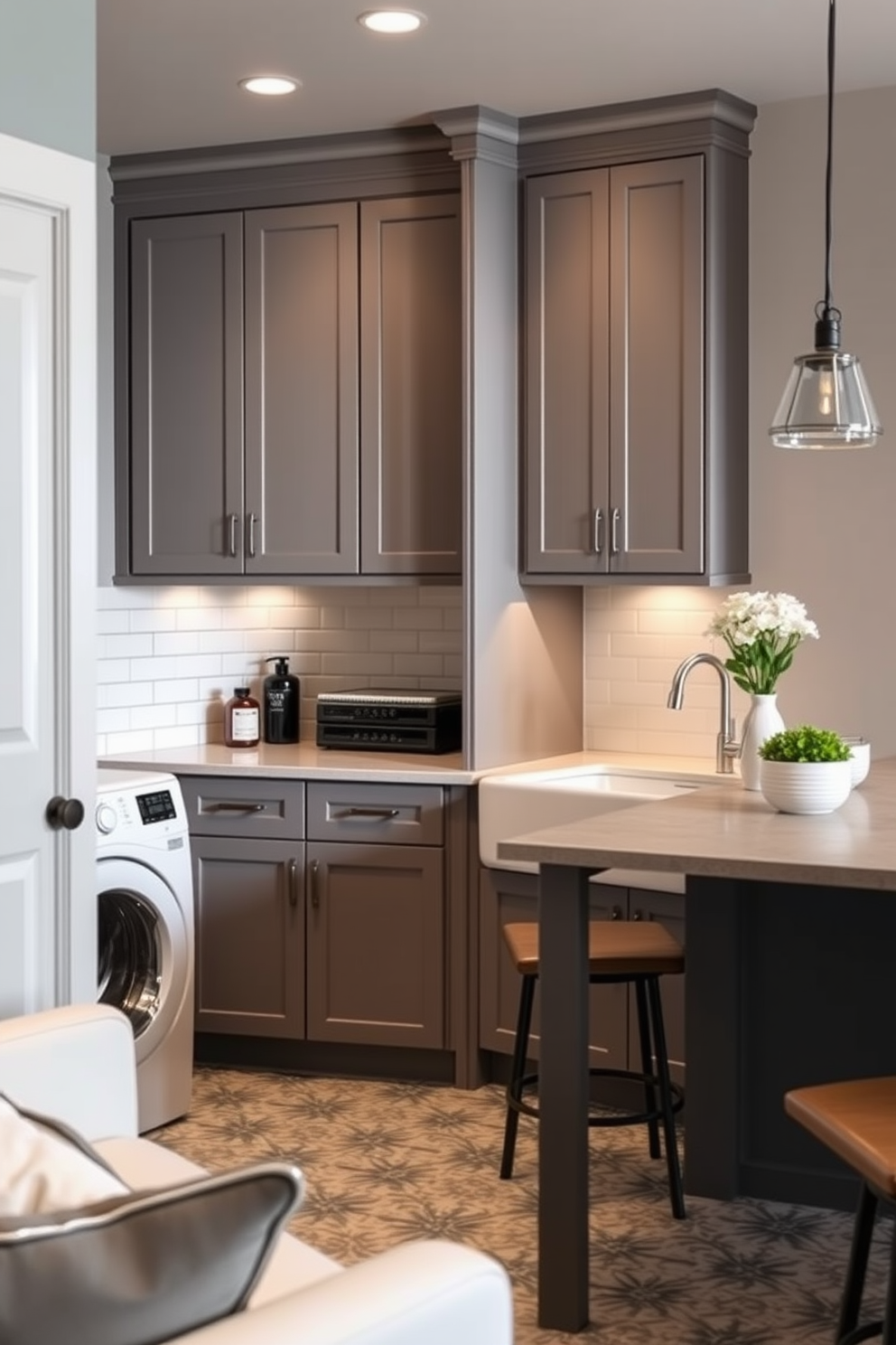 Chic laundry room featuring sleek cabinetry and ample storage space. The walls are painted a soft gray, complemented by a stylish backsplash in white subway tiles. A large countertop provides plenty of room for folding clothes, while a farmhouse sink adds a touch of elegance. The floor is adorned with a patterned tile that adds character to the space. Basement design ideas include a cozy lounge area with plush seating and ambient lighting. Incorporate a wet bar with modern finishes to create an inviting atmosphere for entertaining.