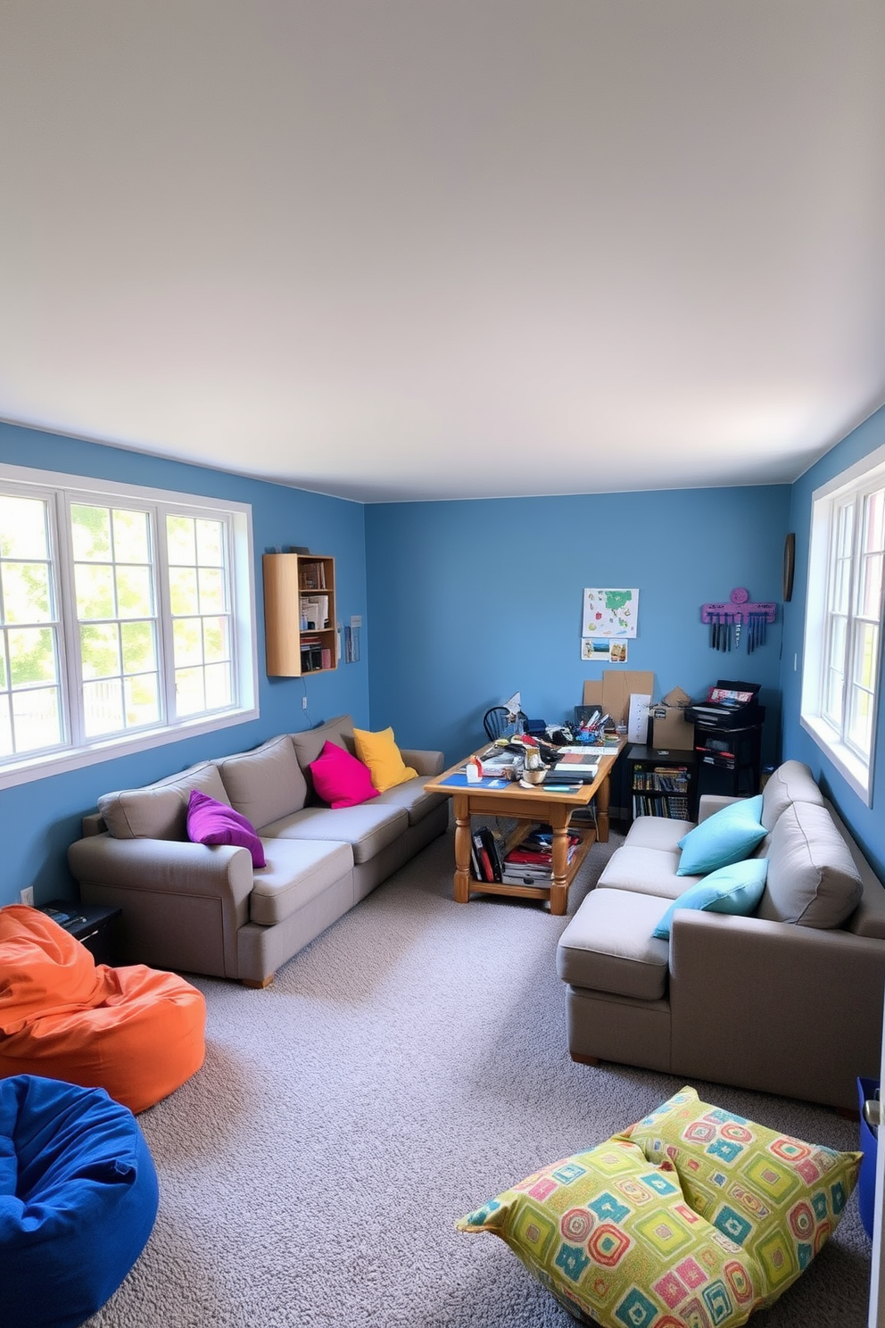 A cozy multi-purpose space designed for hobbies and activities. The room features a large sectional sofa in a warm gray fabric, surrounded by colorful bean bags for extra seating. In one corner, a sturdy wooden table is set up for crafting, adorned with various art supplies and tools. The walls are painted in a soft blue hue, creating a calming atmosphere, while large windows let in ample natural light.