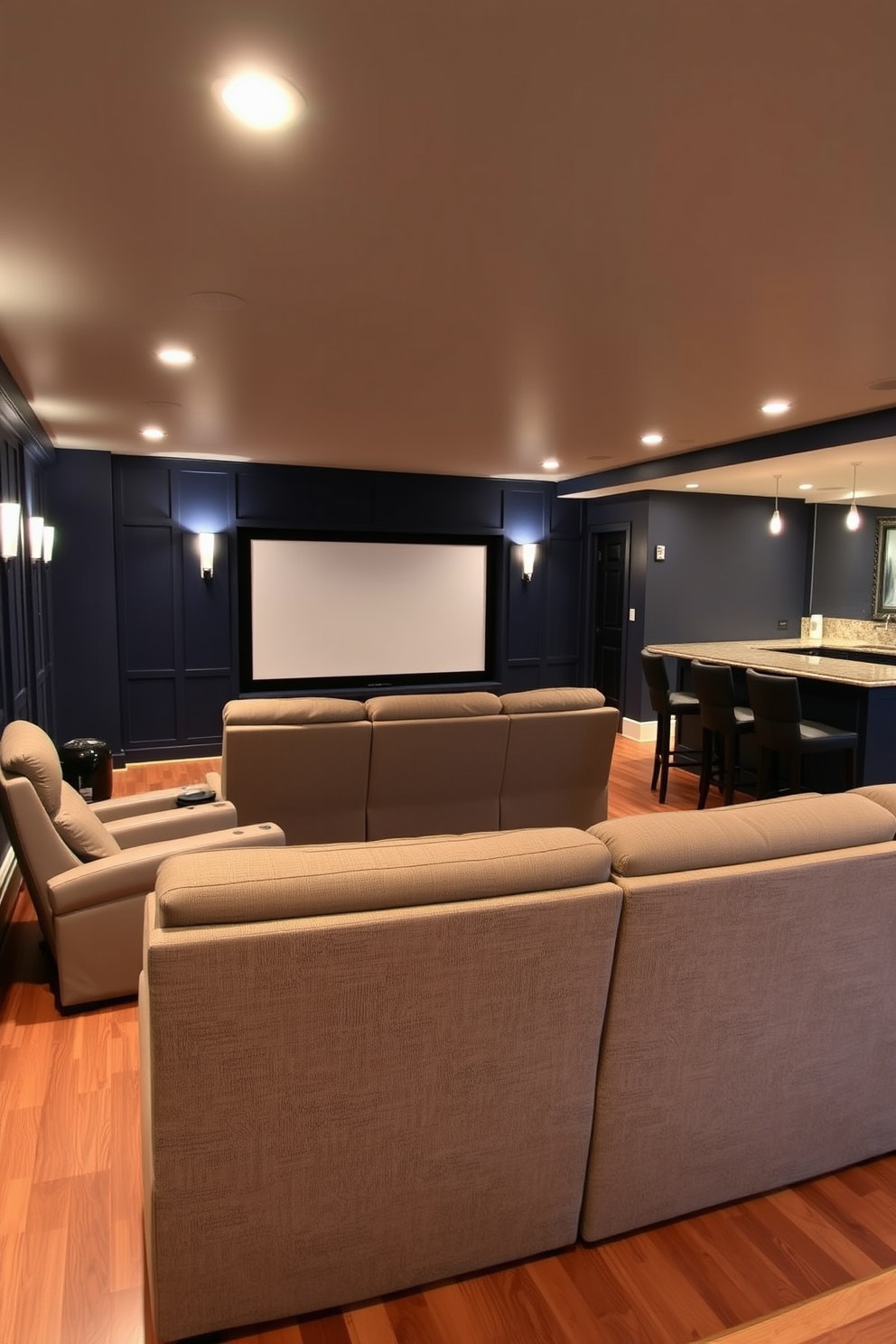 A cozy home theater setup featuring plush recliner seating arranged in a semi-circle facing a large screen. The walls are painted in a deep navy blue, and soft ambient lighting highlights the room's acoustically treated panels. In the basement, a sleek wet bar is positioned to the side, complete with high-top stools and a stylish countertop. The flooring is a warm hardwood, adding a touch of elegance to the overall design.