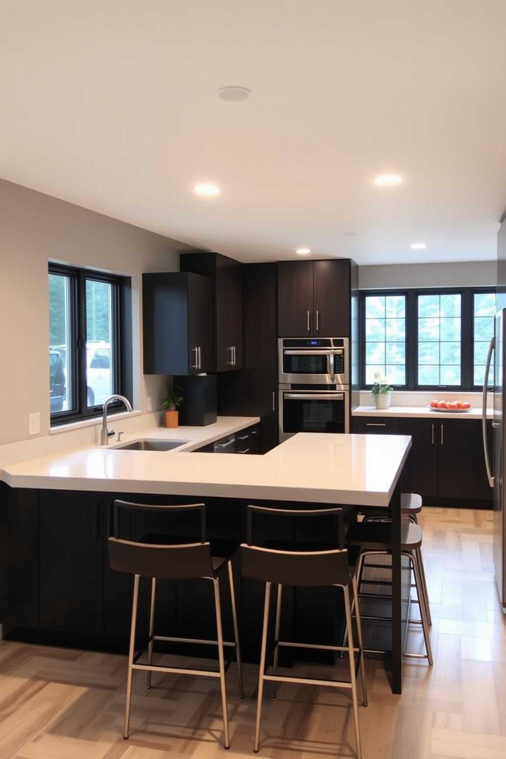 A modern basement kitchen designed for efficiency and social gatherings. The layout features an open space with an island that includes bar seating, allowing for easy interaction while cooking. Sleek cabinetry in a dark finish contrasts with light countertops, creating a stylish yet functional environment. Large windows provide natural light, illuminating the space and enhancing the inviting atmosphere.