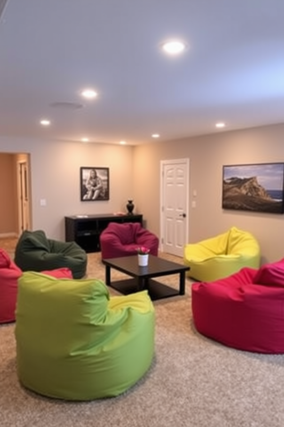 A cozy family-friendly basement living room features colorful bean bag chairs scattered around a low coffee table. The walls are painted in a soft beige, complemented by warm lighting that creates an inviting atmosphere for relaxation and play.