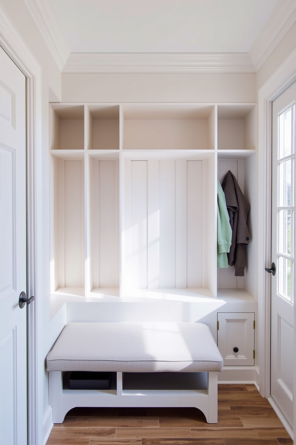 A functional mudroom featuring built-in cubbies designed for organized storage. The cubbies are crafted from light wood and painted in a soft white, providing a bright and airy feel. The space includes a bench for seating, upholstered in a durable fabric suitable for high traffic. A large window allows natural light to flood the area, enhancing the welcoming atmosphere.