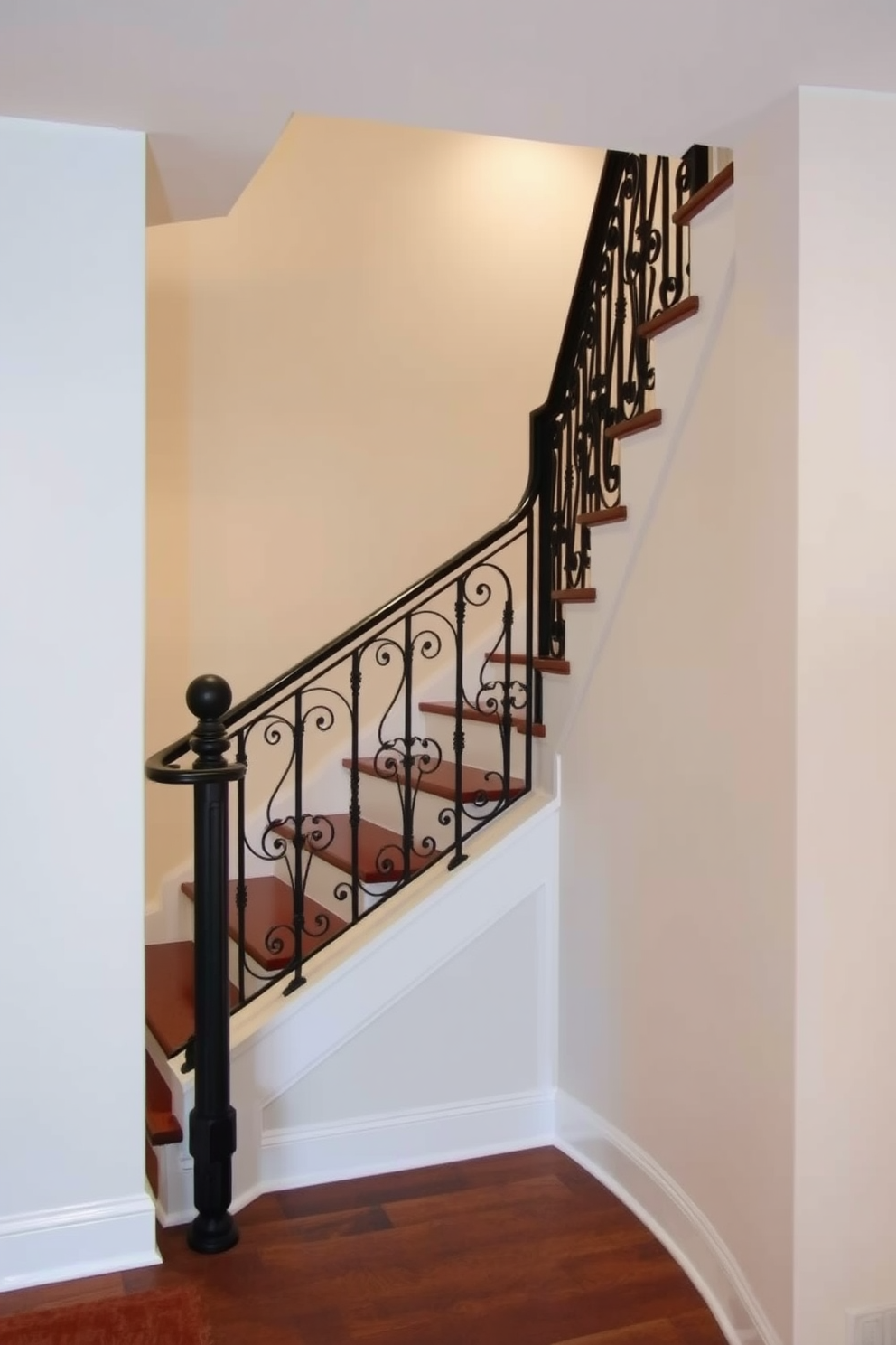 A basement staircase featuring wrought iron railings with intricate scrollwork adds a touch of classic elegance. The staircase is illuminated by soft recessed lighting that highlights the rich wooden steps and enhances the overall ambiance.