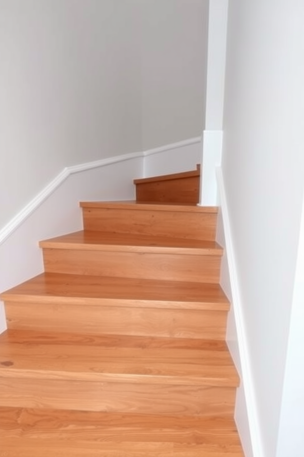 A basement staircase featuring wooden treads that provide warmth and elegance. The contrasting risers in a sleek white finish create a modern and striking visual appeal.