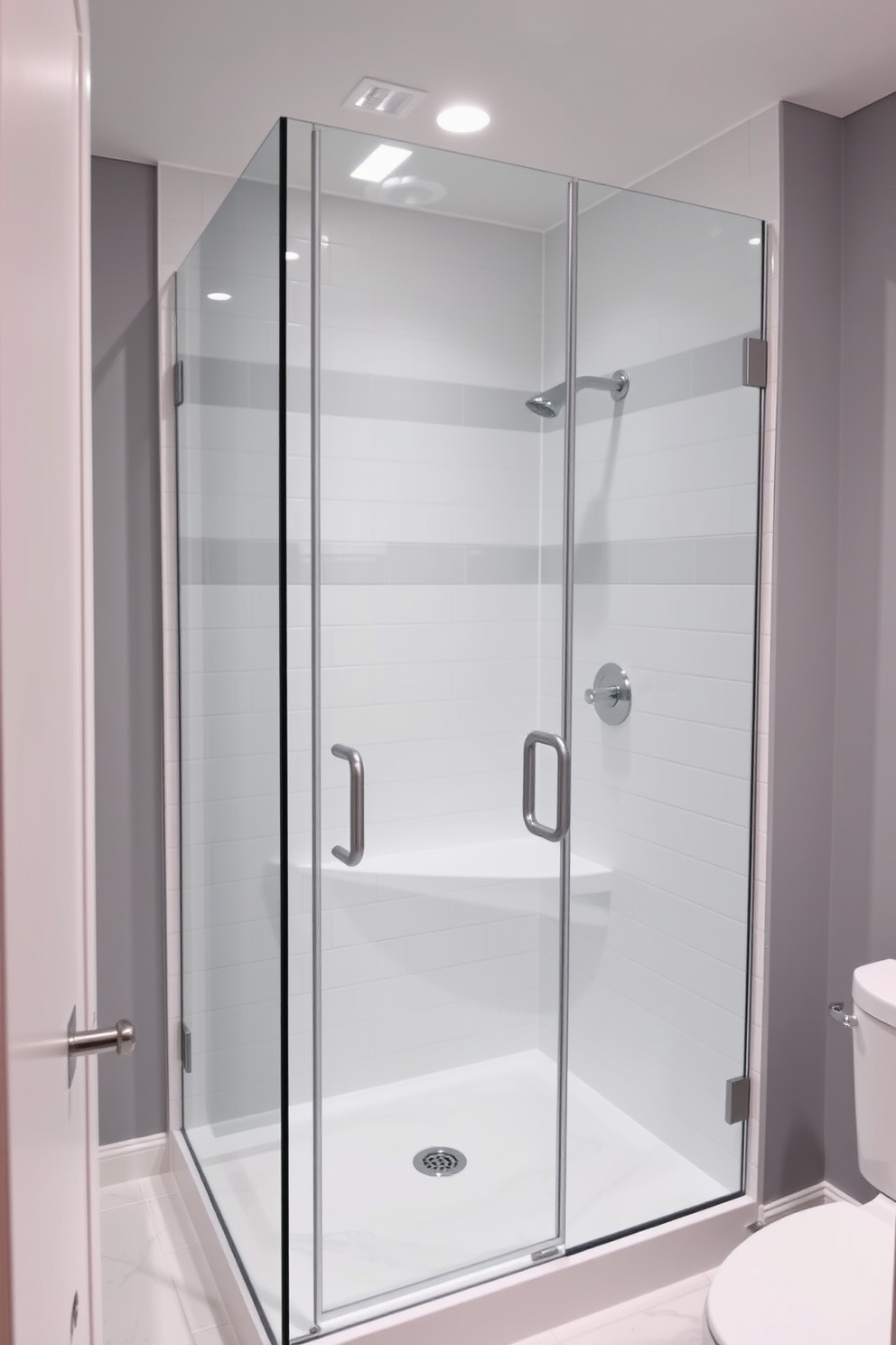 A modern basement washroom featuring a glass shower enclosure that creates a spacious and airy atmosphere. The walls are painted in a soft gray tone, complemented by sleek white tiles on the floor and shower area.