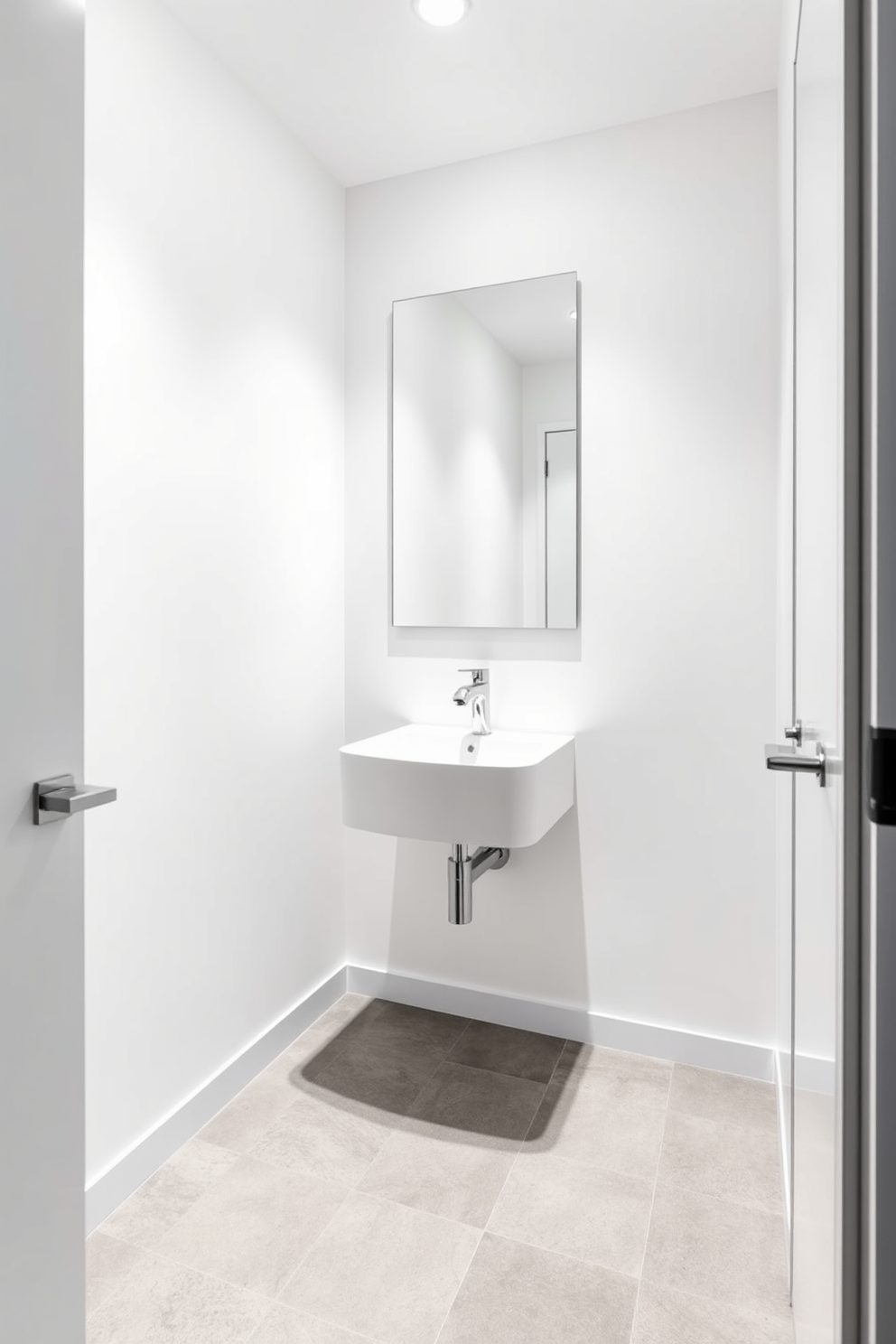 A modern minimalist basement washroom featuring sleek fixtures and a clean aesthetic. The walls are painted in a soft white, and the floor is adorned with large grey tiles, creating a spacious feel. A wall-mounted sink with a simple chrome faucet complements the minimalist design. A large mirror without a frame hangs above the sink, reflecting the bright LED lighting that enhances the room's openness.