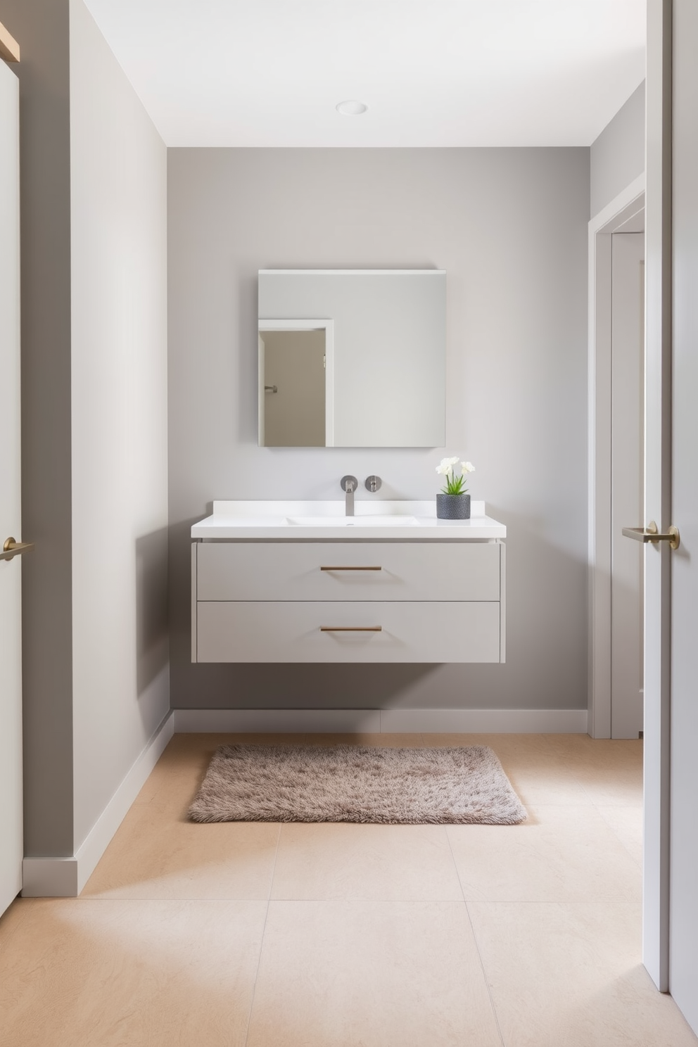 A sleek floating vanity is mounted against a backdrop of soft gray walls, creating a modern and airy feel. The vanity features a minimalist design with a white countertop and integrated sink, complemented by stylish brushed nickel fixtures. The floor is adorned with large format tiles in a light beige tone, enhancing the spaciousness of the basement washroom. To add warmth, a plush area rug in muted tones is placed beneath the vanity, providing a cozy touch to the contemporary aesthetic.