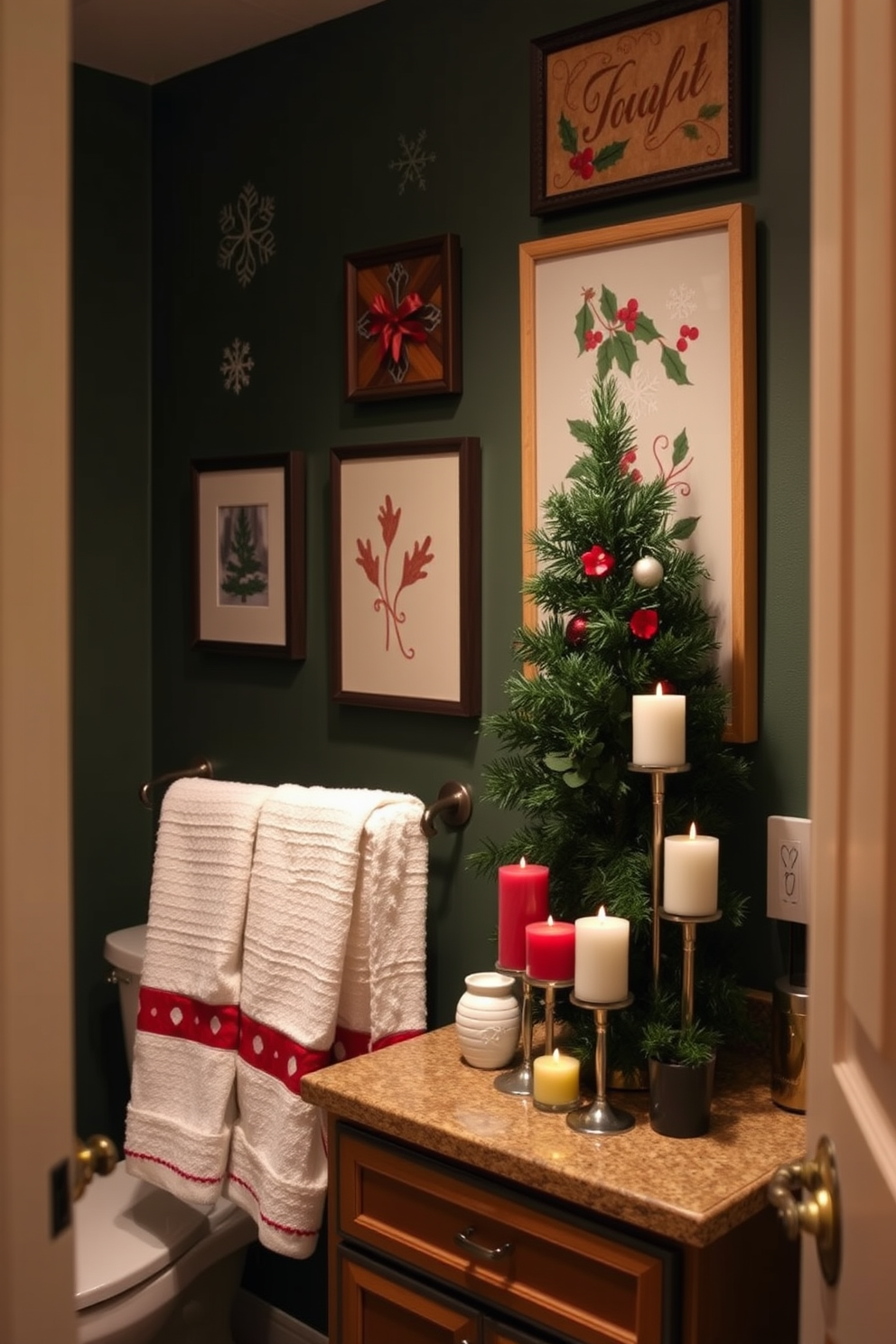 A cozy bathroom adorned with seasonal artwork on the walls. The decorations feature festive themes, including snowflakes and holly, creating a warm holiday atmosphere. The countertop is decorated with a small evergreen tree and a collection of scented candles in holiday colors. Soft white towels with red accents hang neatly on a towel rack, enhancing the cheerful decor.