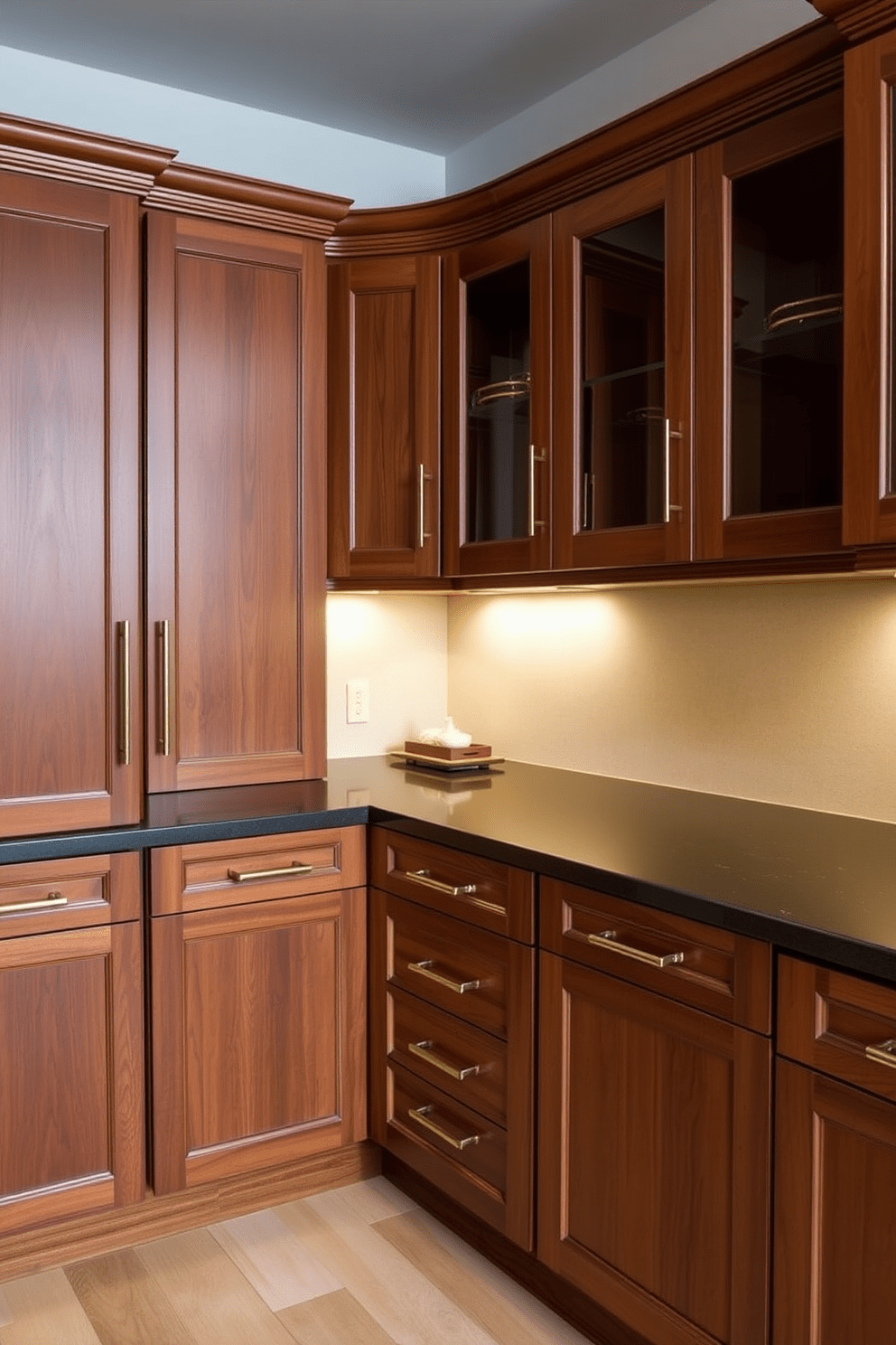 Custom cabinetry for personalized storage. The cabinetry features a blend of rich wood finishes and sleek hardware, designed to maximize space while maintaining a sophisticated aesthetic. The cabinets are arranged in a U-shape, creating an inviting and functional layout. Soft under-cabinet lighting highlights the elegant design and adds warmth to the overall ambiance.