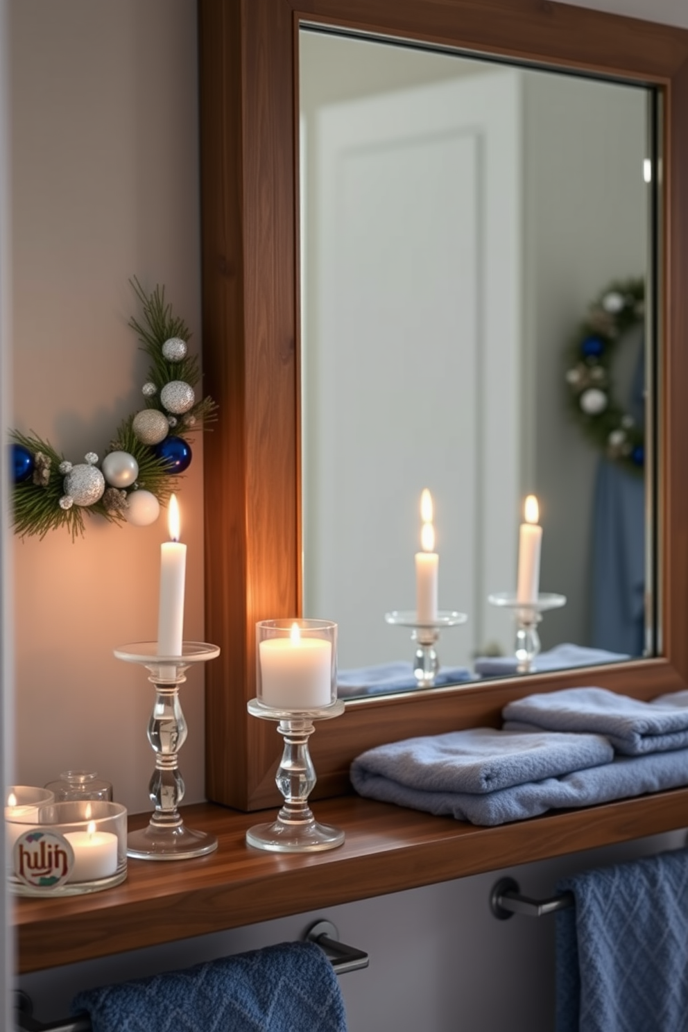 Festive candles in elegant glass holders are arranged on a wooden shelf, casting a warm glow throughout the bathroom. The space is adorned with subtle Hanukkah decorations, including blue and silver accents that complement the serene atmosphere. A large mirror reflects the flickering candlelight, enhancing the cozy ambiance. Soft, fluffy towels in shades of blue are neatly displayed, adding a touch of luxury to the festive decor.