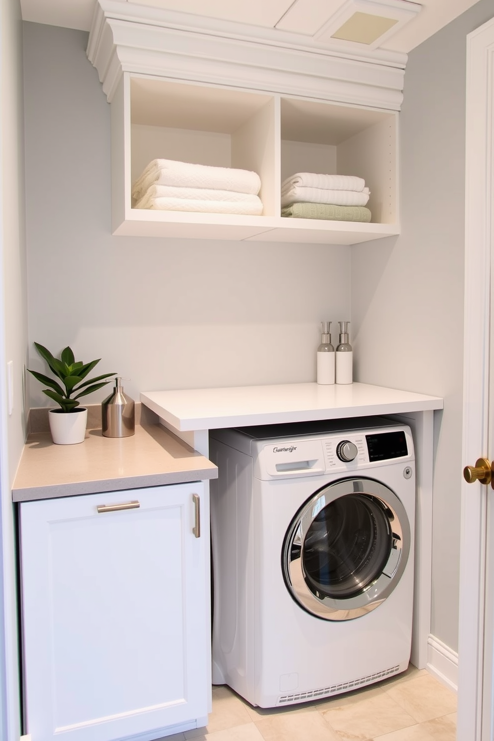 A compact stacked washer dryer setup is seamlessly integrated into a stylish bathroom laundry room combo. The space features sleek cabinetry in a soft white finish, with the washer and dryer tucked away beneath a countertop that provides additional workspace. Above the appliances, open shelving displays neatly folded towels and laundry essentials, adding both functionality and aesthetic appeal. The walls are painted in a light gray hue, creating a fresh and airy atmosphere, while a small potted plant adds a touch of greenery to the design.