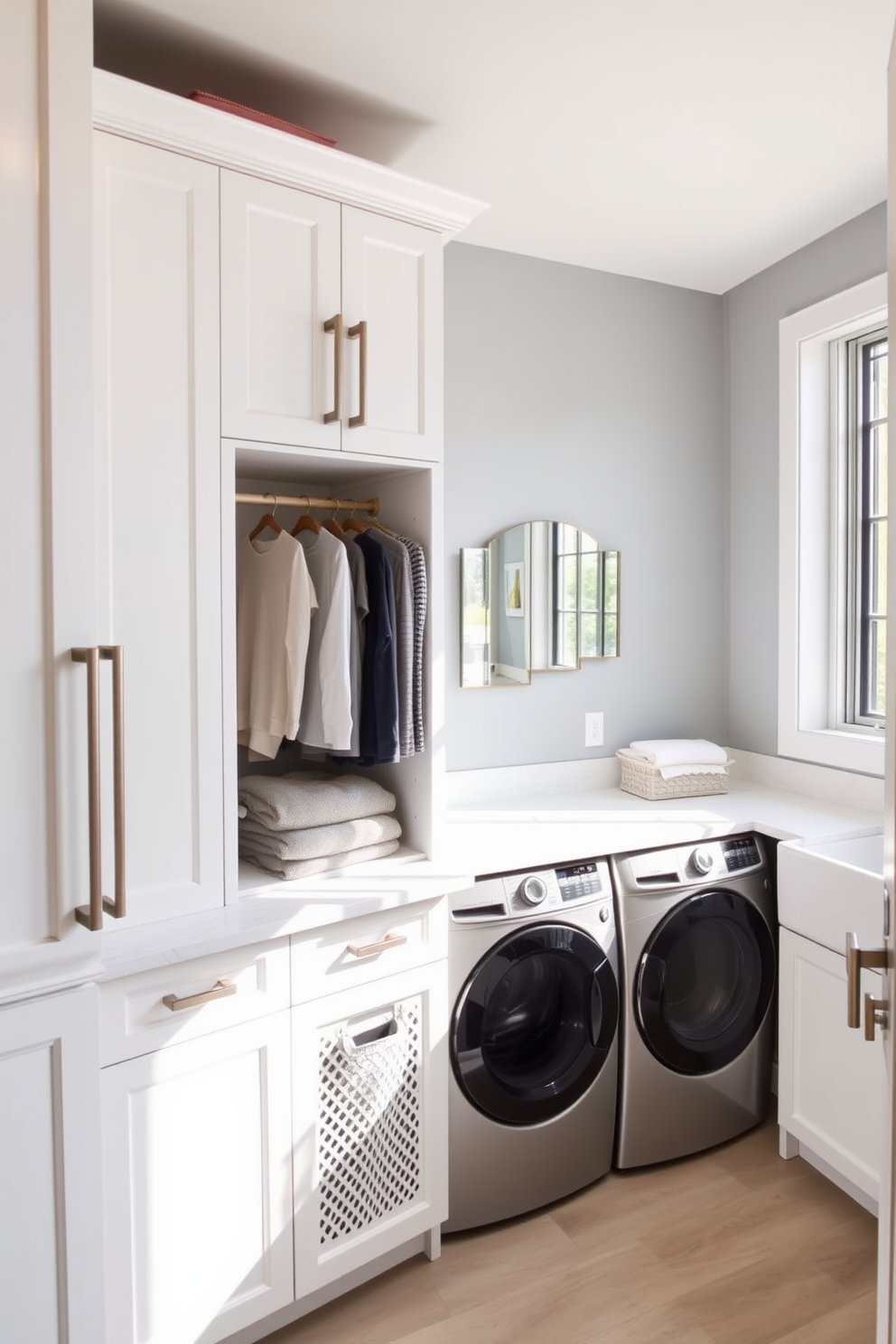 A modern laundry room featuring built-in hampers seamlessly integrated into cabinetry for easy sorting of clothes. The space includes a stylish countertop for folding laundry and a large sink for handwashing delicate items. The walls are painted in a soft gray hue, complemented by white cabinetry and sleek hardware. Natural light floods the room through a large window, enhancing the inviting atmosphere of this functional space.