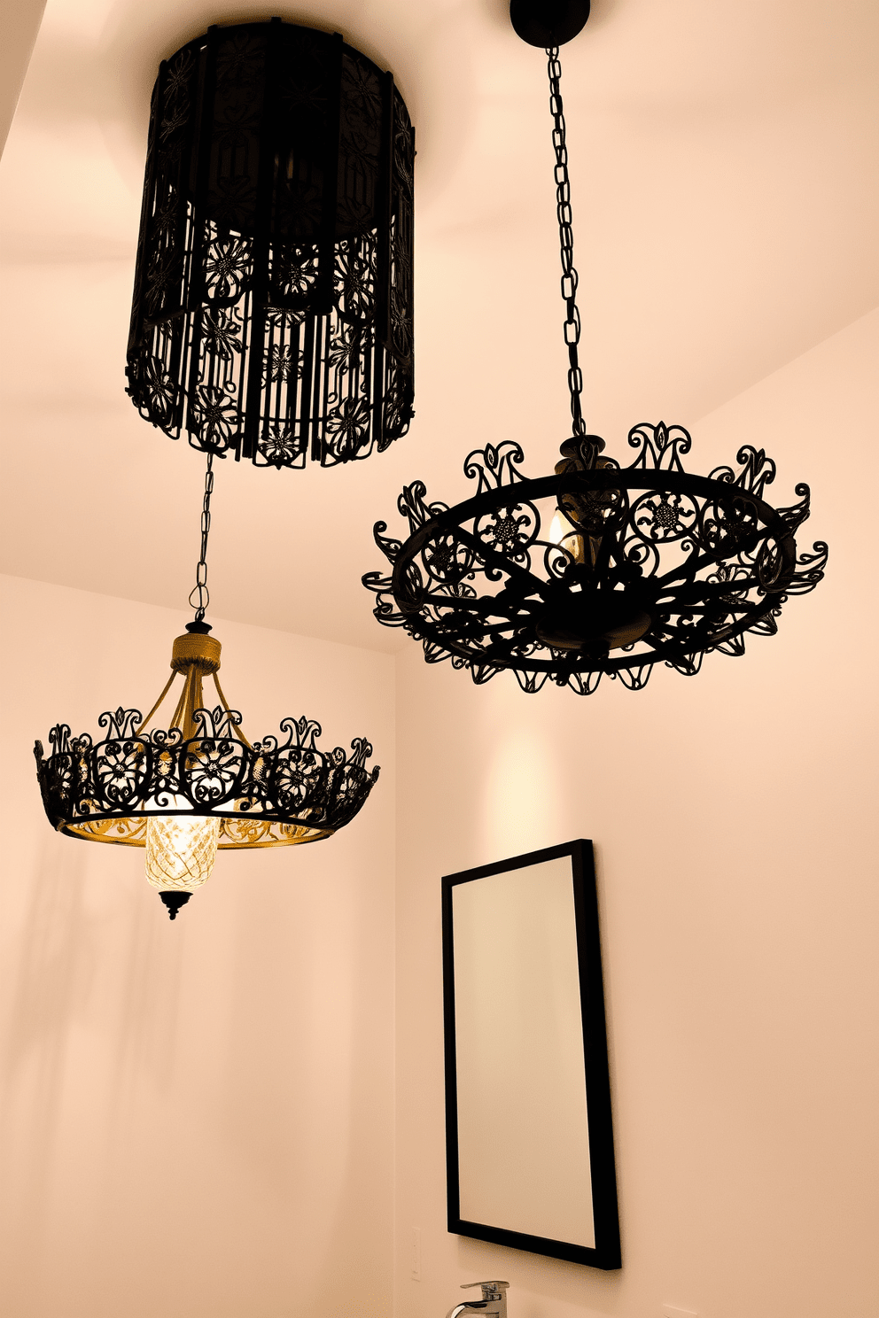 Artistic light fixtures hang elegantly from the ceiling, creating a stunning focal point in the room. The fixtures feature intricate designs and a mix of materials, casting a warm glow that enhances the overall ambiance. The walls are painted in a soft neutral tone, providing a perfect backdrop for the unique lighting. Below, a sleek vanity with a polished countertop complements the artistic elements above, creating a harmonious balance in the space.