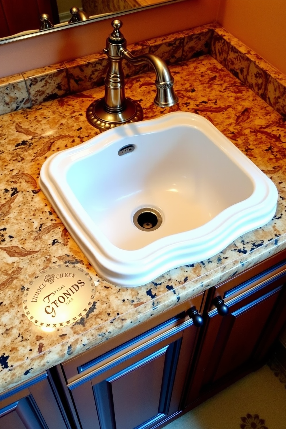 A traditional undermount sink is elegantly integrated into a classic bathroom setting. The sink is surrounded by a polished granite countertop, featuring intricate detailing and a warm color palette. The cabinetry beneath the sink showcases rich wood finishes with ornate hardware. A vintage-style faucet complements the sink, adding a touch of timeless sophistication to the overall design.