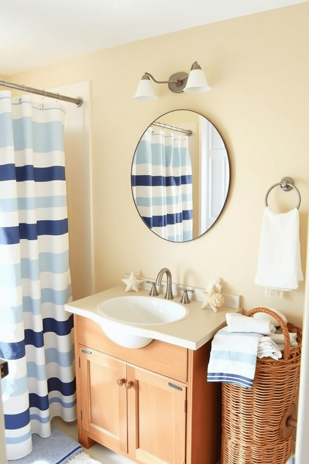 A bright and airy beach bathroom featuring nautical stripes in the shower curtains. The walls are painted a soft sandy beige, complementing the light blue accents throughout the space. A wooden vanity with a white sink sits beneath a large round mirror, reflecting the coastal theme. Seashell decorations and a wicker basket filled with towels add a charming touch to the overall design.