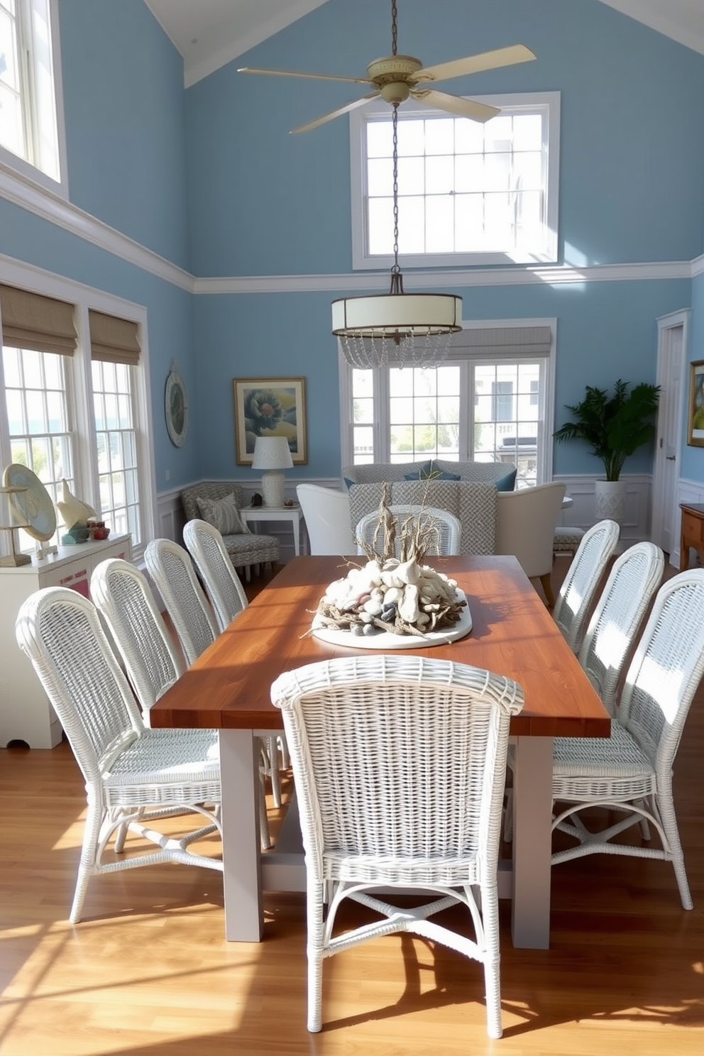 Nautical themed decor featuring seashell accents creates a refreshing and inviting atmosphere. The dining room showcases a large wooden table surrounded by white wicker chairs, with a centerpiece made of assorted seashells and driftwood. The walls are painted in soft blue tones, reminiscent of the ocean, while nautical-themed artwork adorns the space. Natural light floods in through large windows, enhancing the beachy vibe and illuminating the coastal-inspired decor.