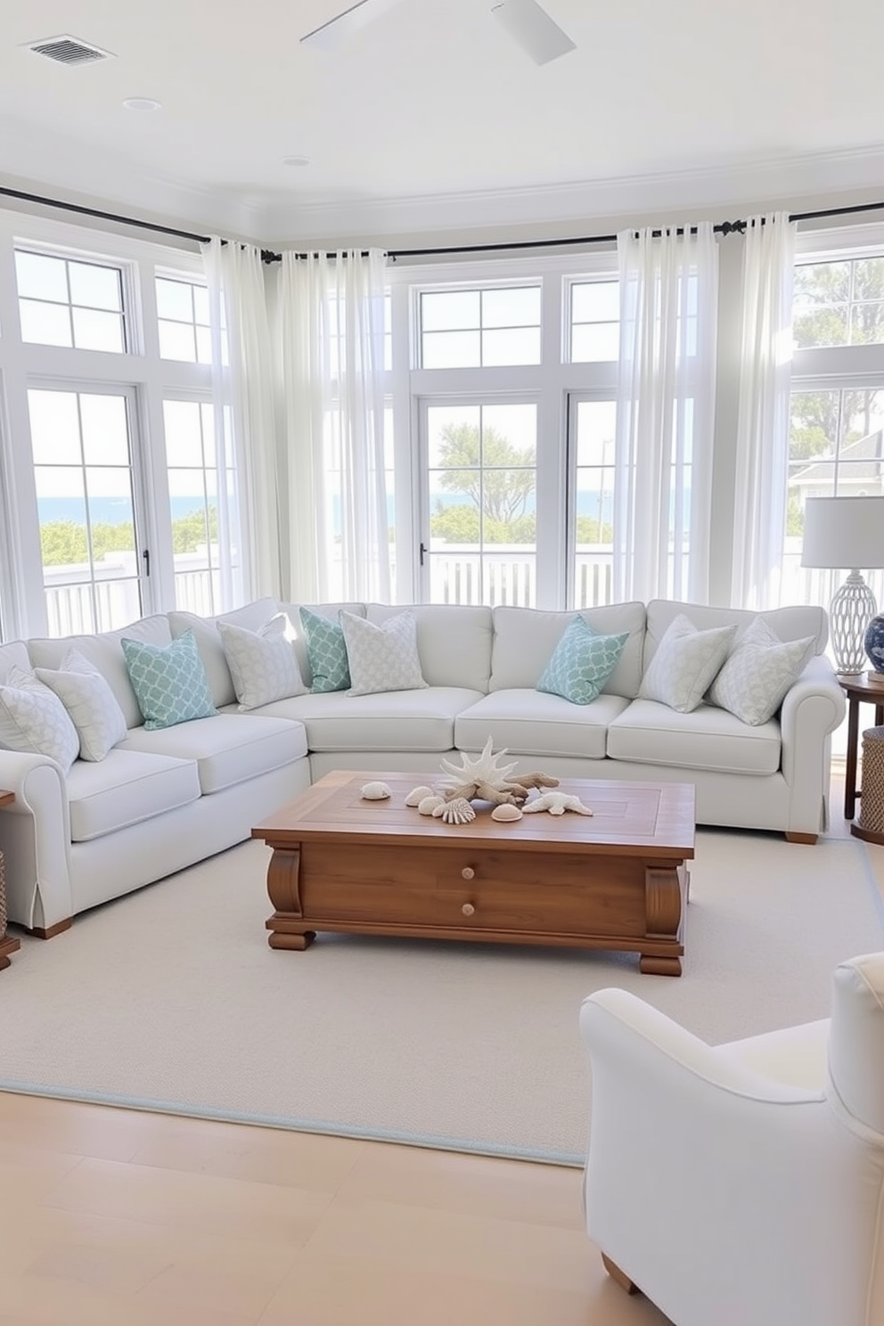 A bright and airy beach living room featuring a color palette of soothing blues and crisp whites. The room includes a large sectional sofa adorned with light blue and white throw pillows, complemented by a matching area rug. Natural light floods the space through large windows draped with sheer white curtains, enhancing the coastal vibe. A wooden coffee table sits in the center, surrounded by beach-themed decor such as seashells and driftwood accents.