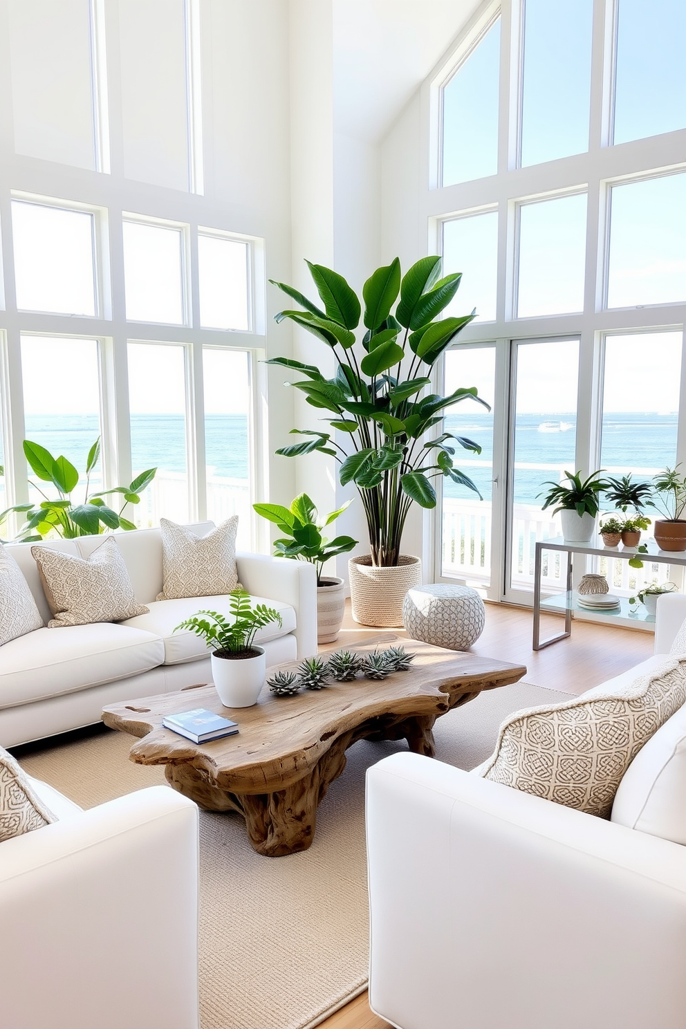 A bright and airy beach living room filled with natural light. Plush white sofas are arranged around a driftwood coffee table, and large windows offer a stunning ocean view. Lush indoor plants are strategically placed throughout the space, adding vibrant greenery to the decor. A tall fiddle leaf fig stands in one corner, while smaller succulents adorn the coffee table and shelves.