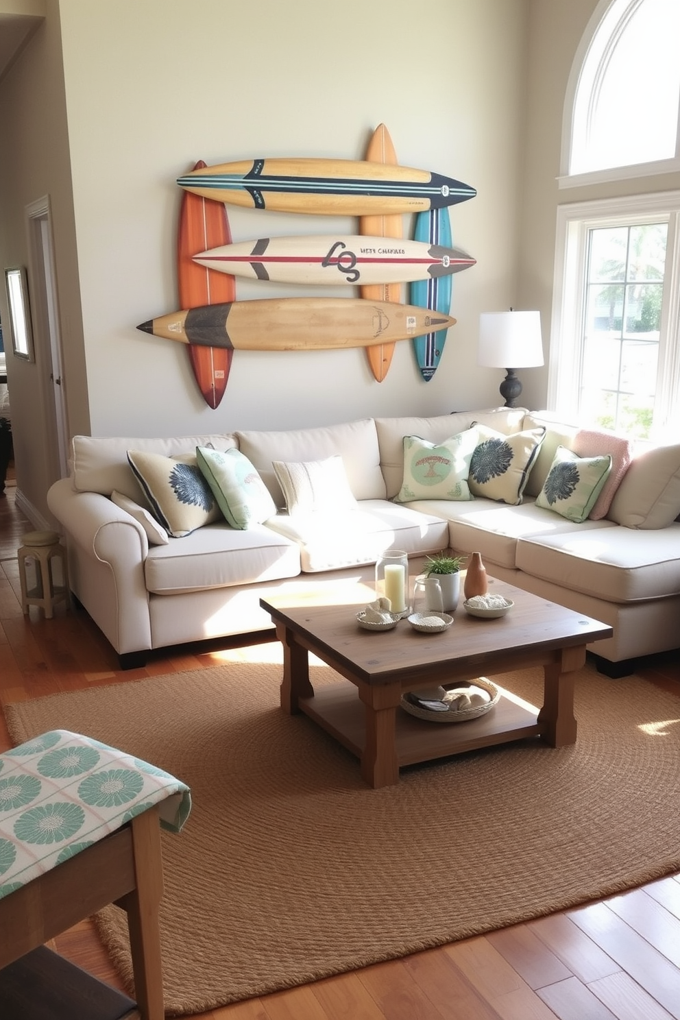 A cozy beach living room featuring vintage surfboards as wall decor. The space is filled with natural light, showcasing a comfortable sectional sofa adorned with ocean-themed throw pillows. The walls are painted in a soft sandy beige, complementing the warm wooden flooring. A large jute rug anchors the seating area, and a reclaimed wood coffee table sits at the center, surrounded by beach-inspired accessories.