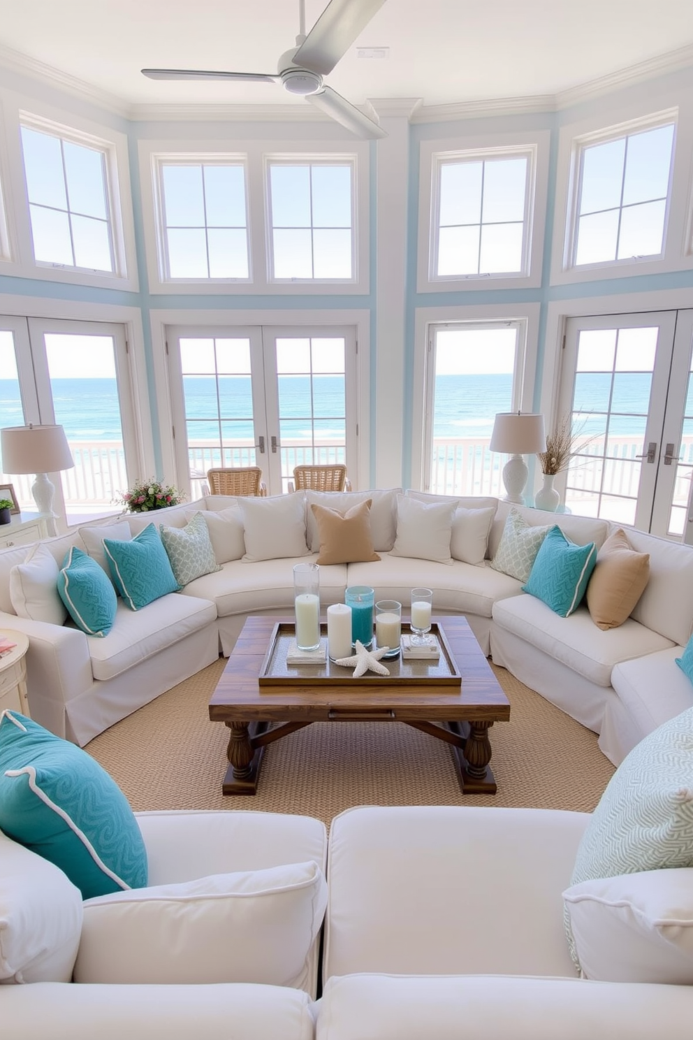 A beach-inspired living room filled with natural light. The space features a large sectional sofa in soft white fabric, accented with turquoise and sandy beige throw pillows. A wooden coffee table sits in the center, adorned with beach-themed decor and a few scented candles. The walls are painted in a light, airy blue, and large windows offer a view of the ocean.