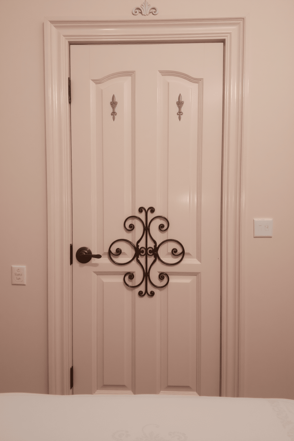 A decorative bedroom door featuring intricate metal accents that enhance its elegance. The door is painted in a soft pastel color, creating a harmonious contrast with the surrounding walls.